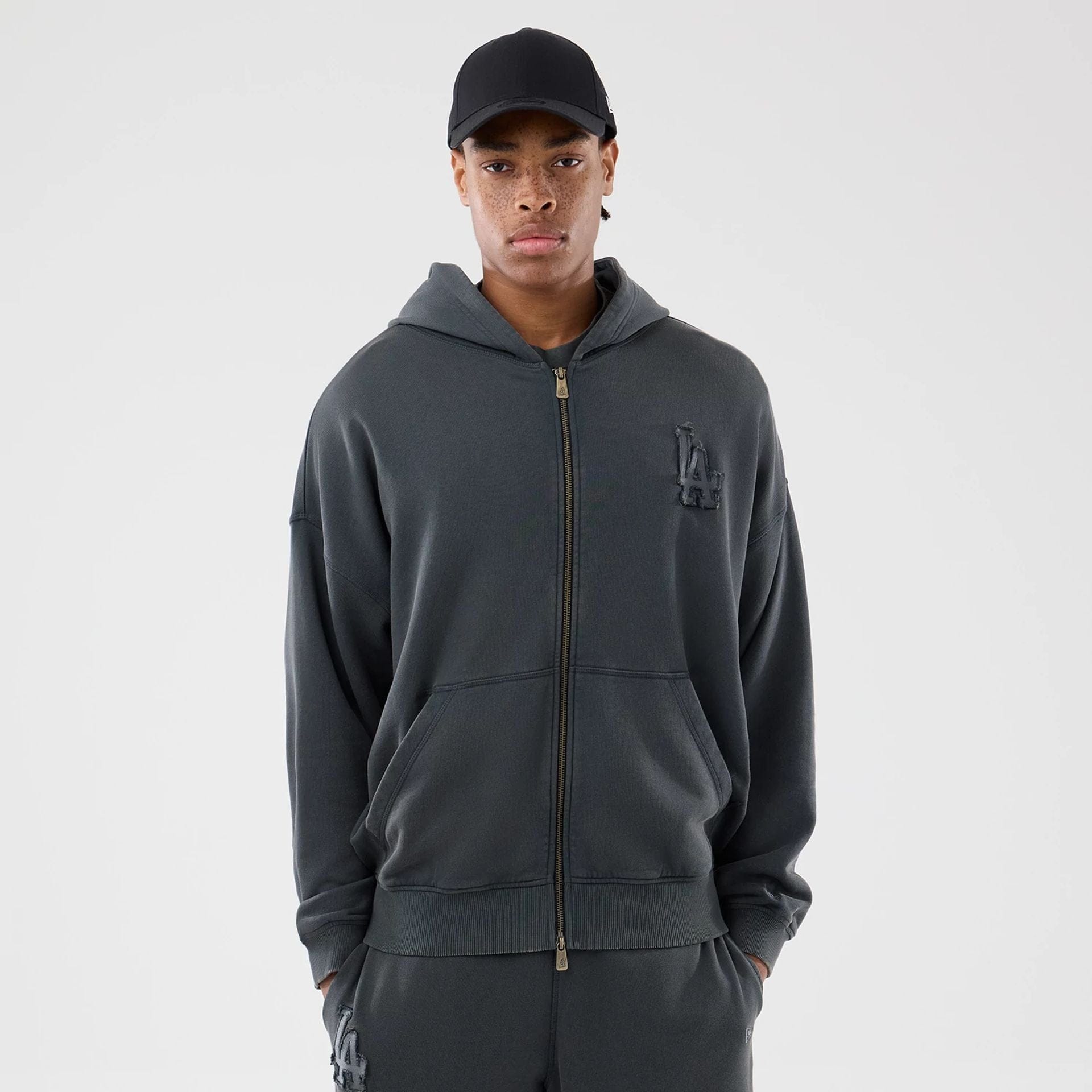 The model is wearing this MLB Washed LA Dodgers Full Zip Hoodie in Dark Grey. 1