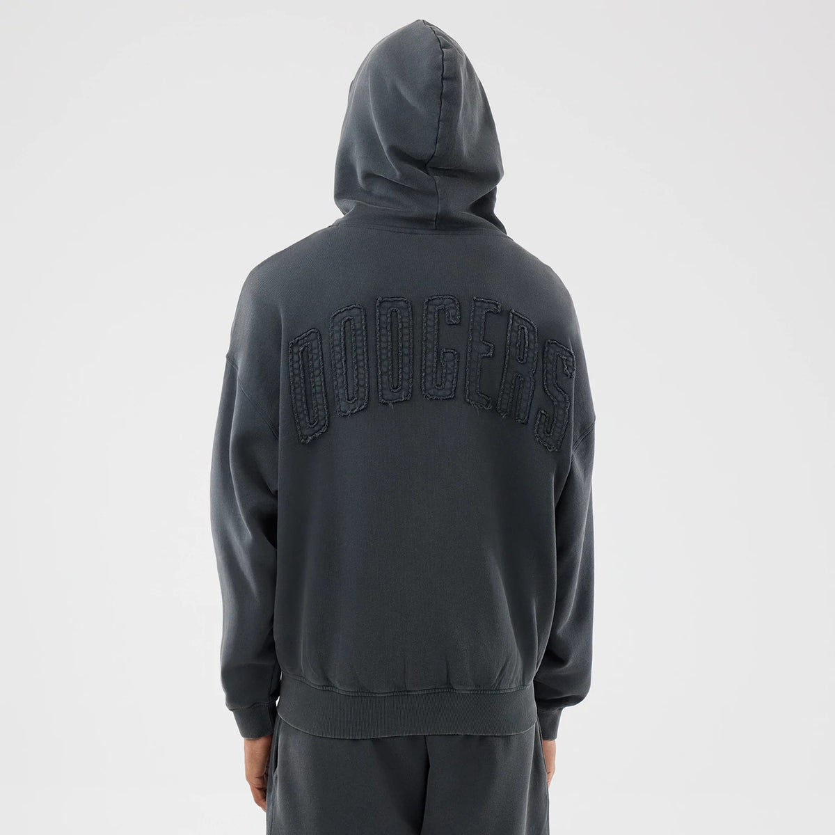 New Era LA Dodgers MLB Washed Dark Grey Full Zip Hoodie, back view showing oversized Dodgers lettering in raised embroidery across the shoulders on a dark grey hooded design worn by a model.