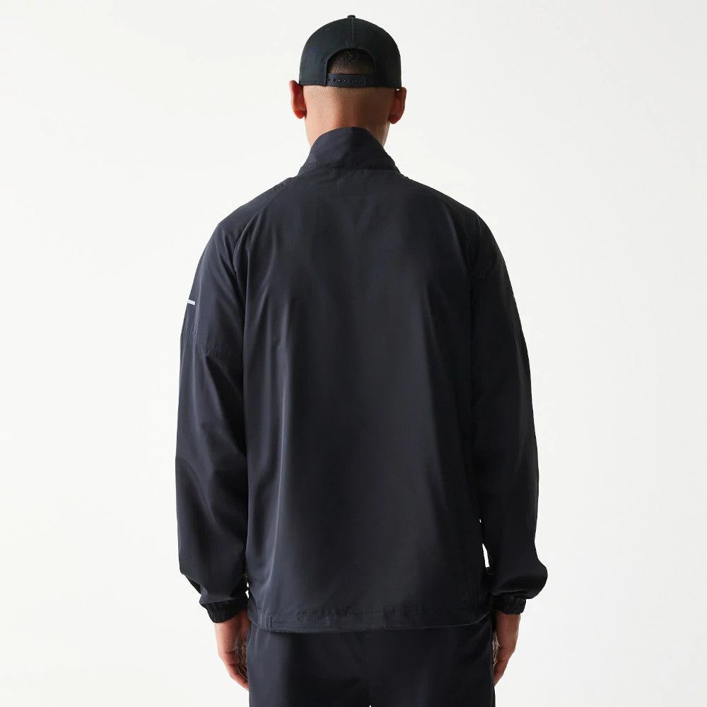 The model is wearing this MLB Reflective Strip New York Yankees Jacket in black. 2