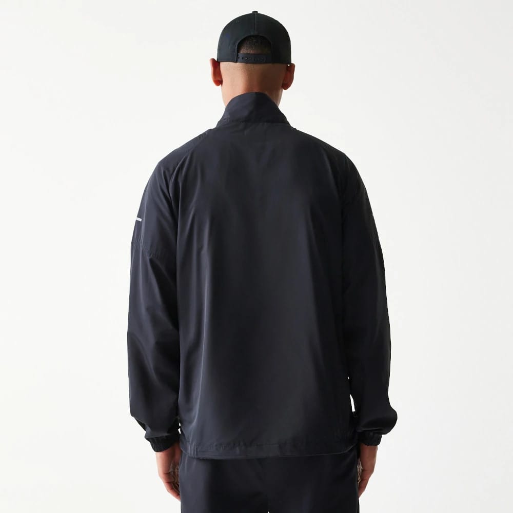 The model is wearing this MLB Reflective Strip New York Yankees Jacket in black. 2