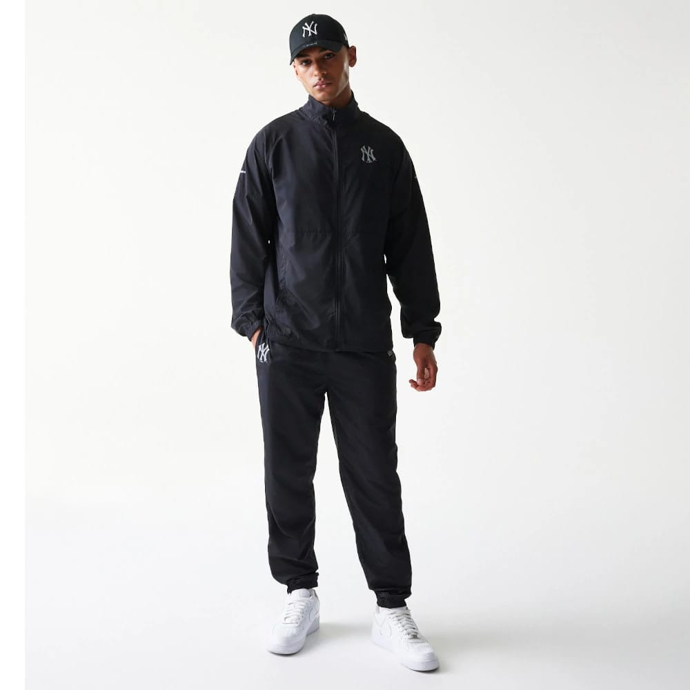 The model is wearing this MLB Reflective Strip New York Yankees Jacket in black. 8