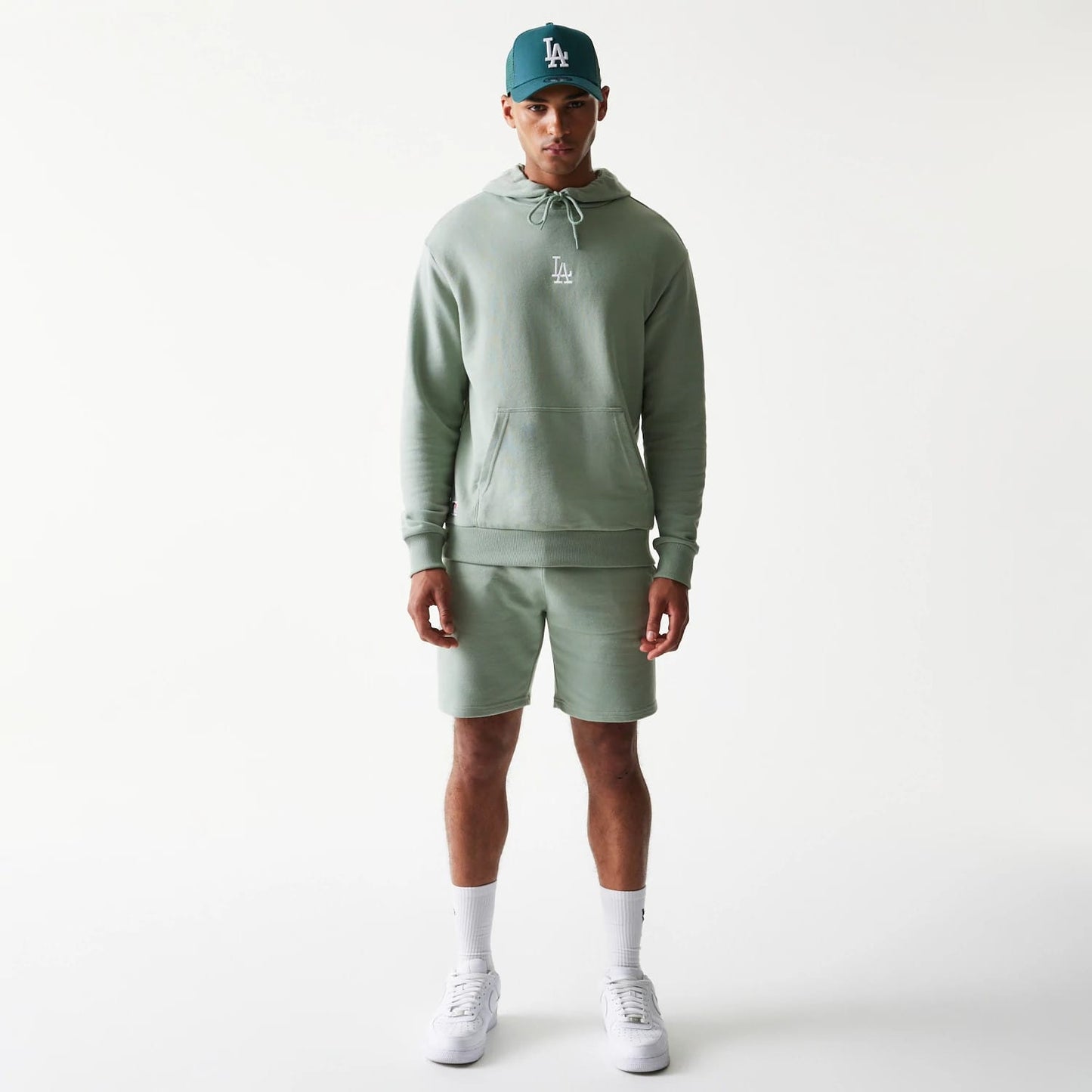 The model is wearing this MLB League Essential Midi LA Dodgers Oversized Pullover Hoodie in green. 8