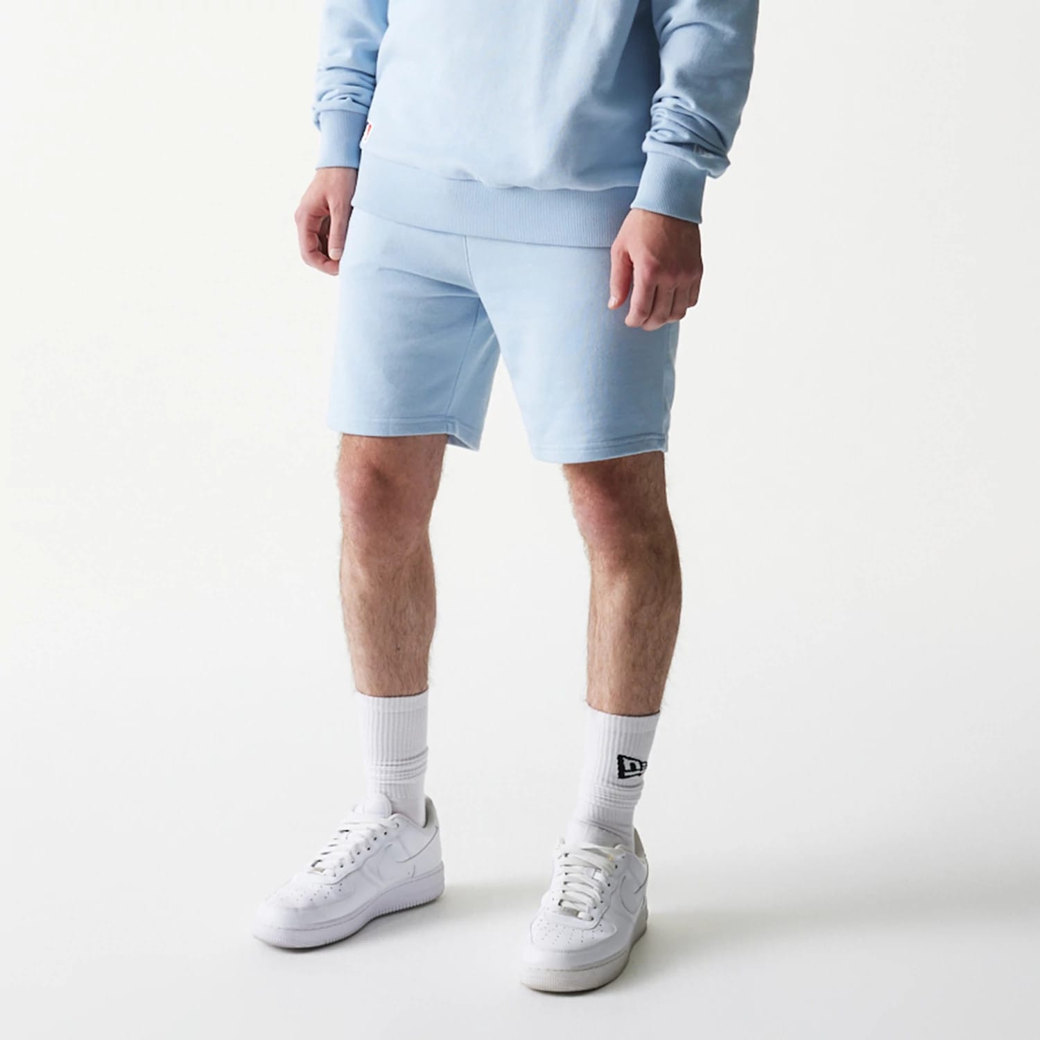 The model is wearing this MLB League Essential Midi New York Yankees Shorts in blue. 3