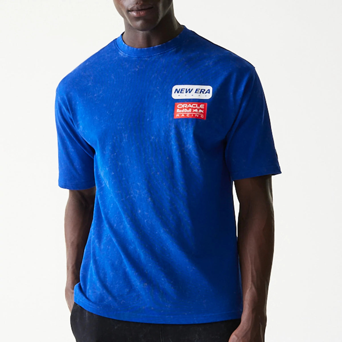 New Era Red Bull Racing Linear Graphic Blue Oversized T-Shirt, front view on a model showing a blue colour with a printed New Era logo and a Red Bull Racing badge on the upper left chest.