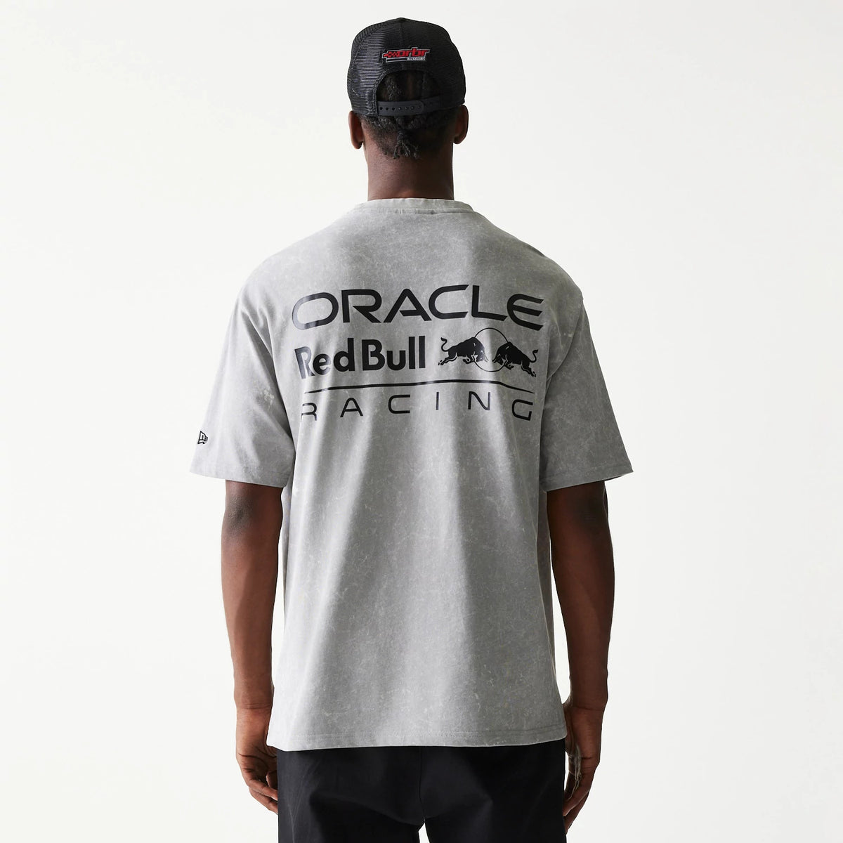 New Era Red Bull Racing Linear Graphic Grey Oversized T-Shirt, back view on a model showing black Oracle Red Bull Racing lettering across the upper back and a small New Era embroidered logo on the left sleeve.