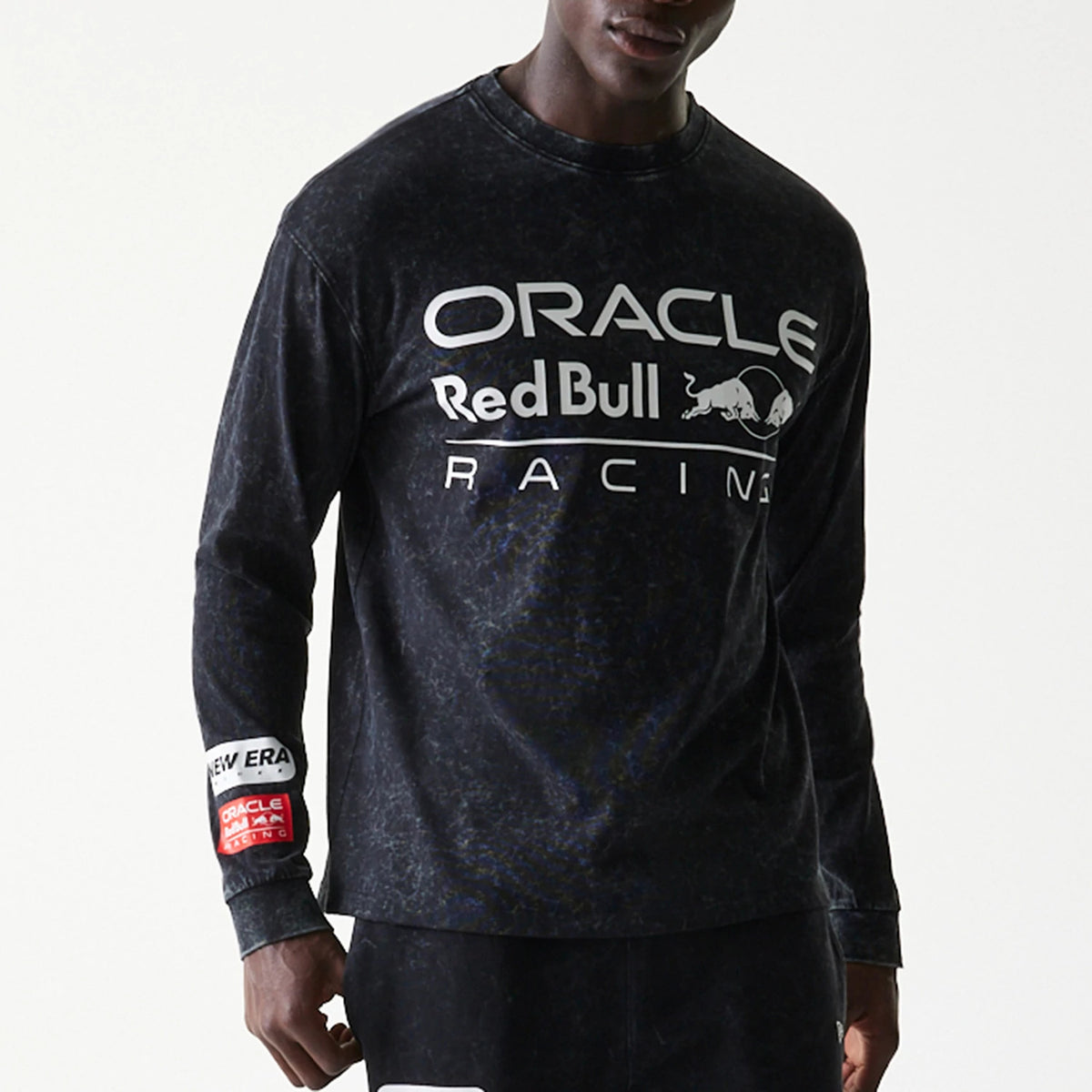 New Era Red Bull Racing Linear Graphic Black Long Sleeve T-Shirt, front view on-model showing the printed Oracle Red Bull Racing logo across the chest and the New Era patch with a red graphic on the left sleeve.