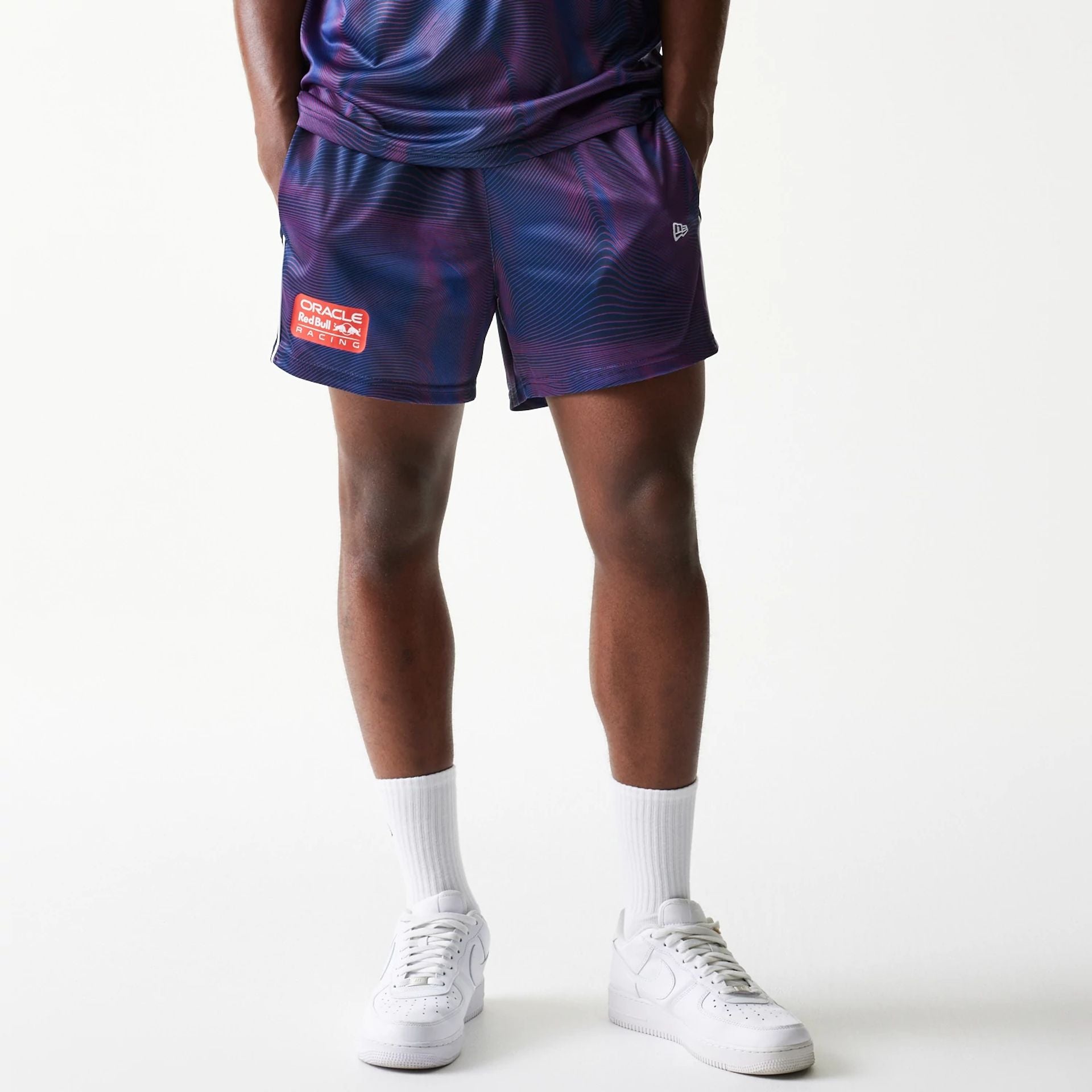 The model is wearing this Red Bull Racing All Over Print Football Shorts in dark blue. 1