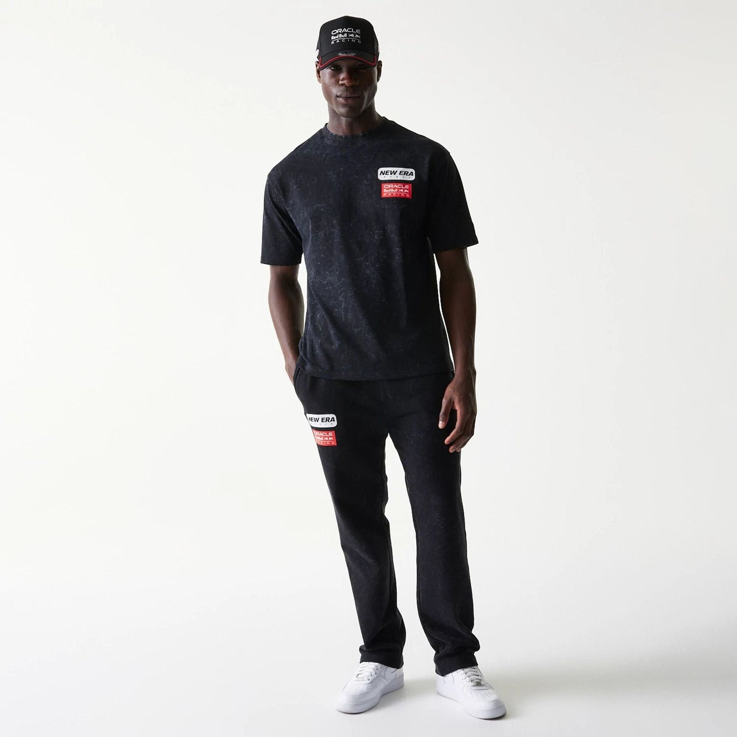 The model is wearing this Red Bull Racing Linear Graphic Oversized T-Shirt in black. 8