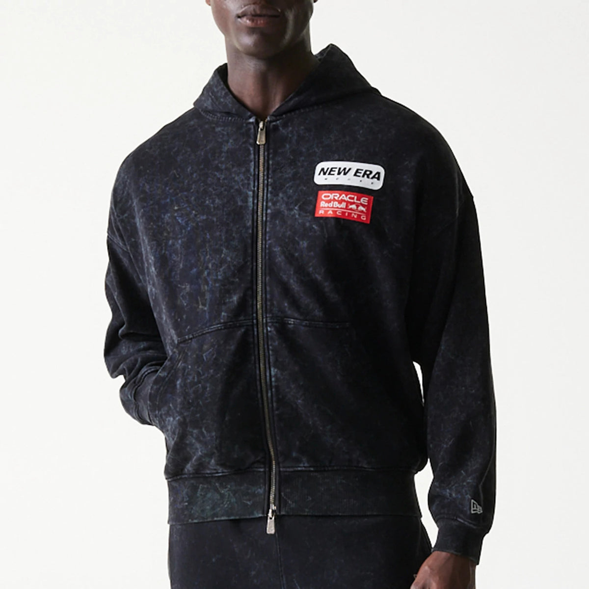 New Era Red Bull Racing Dropped Shoulder Black Dropped Shoulder Full Zip Hoodie, front view with printed New Era and Oracle Red Bull Racing logos on the chest, zip closure, worn by a model.