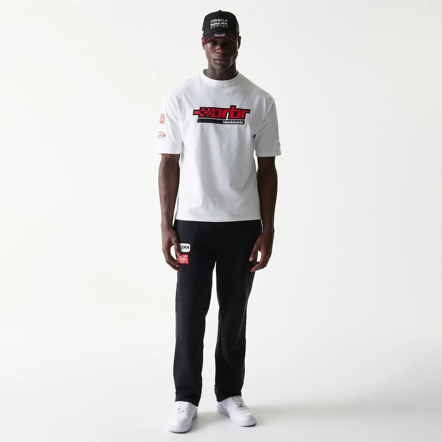 The model is wearing this Red Bull Racing Graphic Oversized T-Shirt in white. 8