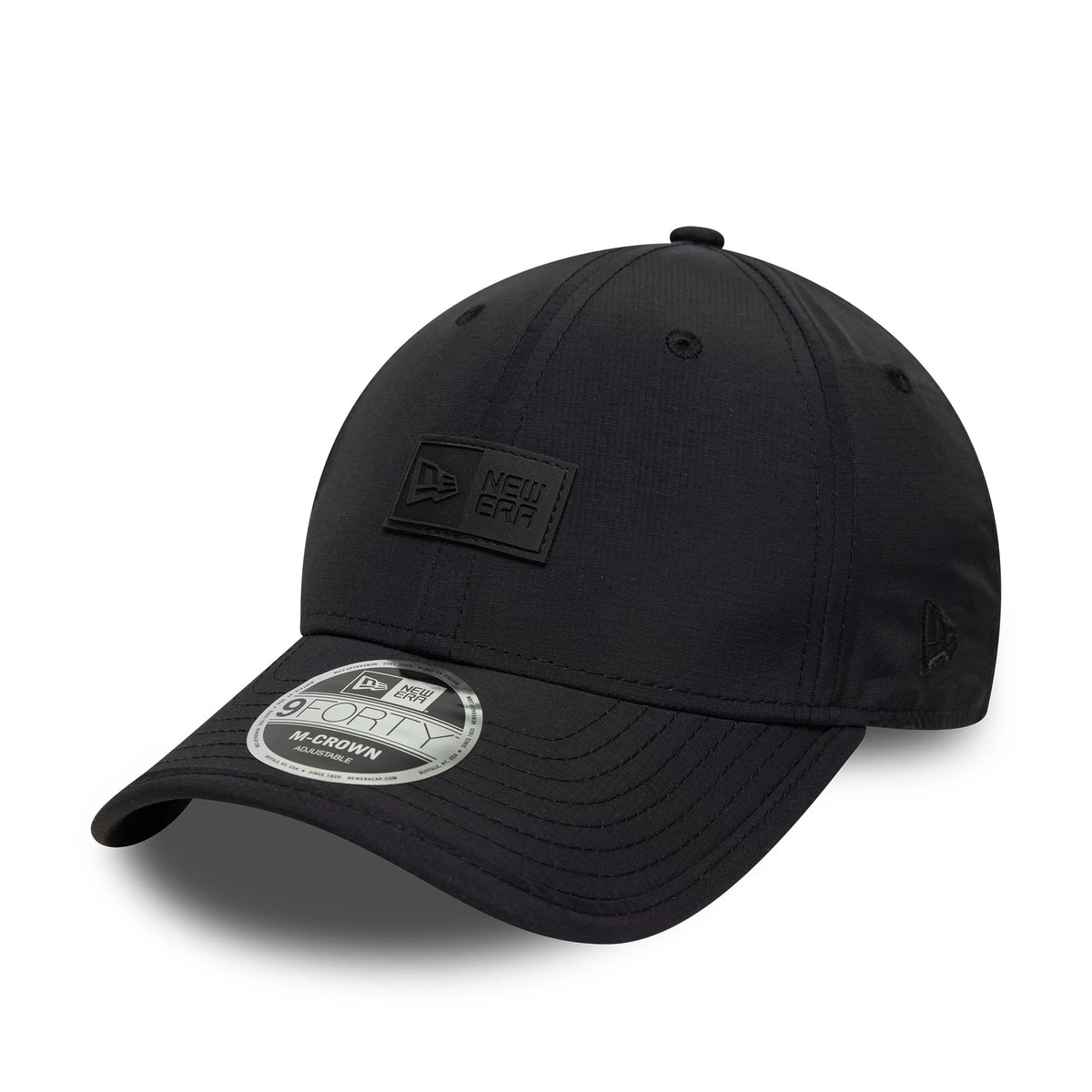 New Era Sport Black 9FORTY M-Crown Cap, three-quarter view showing a New Era logo patch on the front panel, a curved black visor with a 9FORTY size sticker, and an embroidered New Era flag logo on the left side.