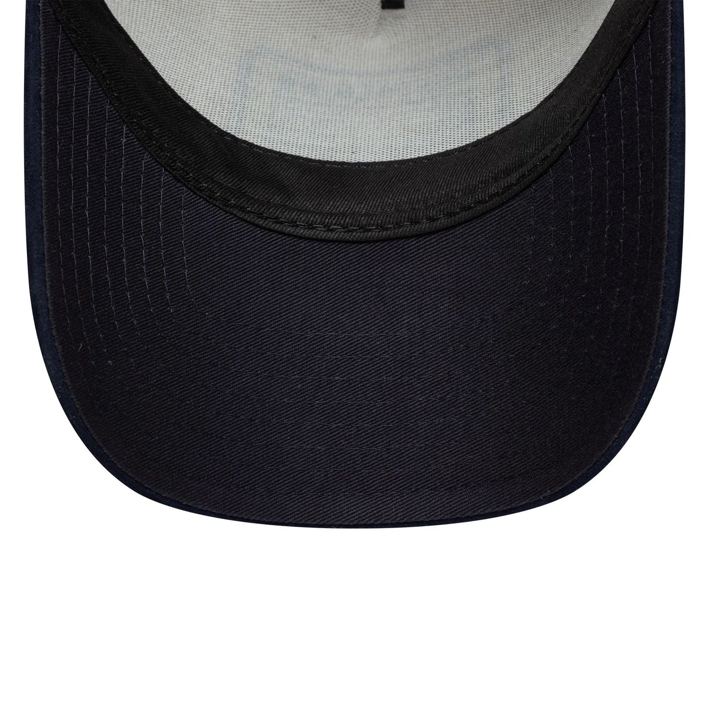 New Era Patch Suede Cream & Navy 9FORTY E-Frame Cap, inside view showing the dark navy undervisor contrasting with the cream internal taping and light grey sweatband, highlighting the cap's structured design.