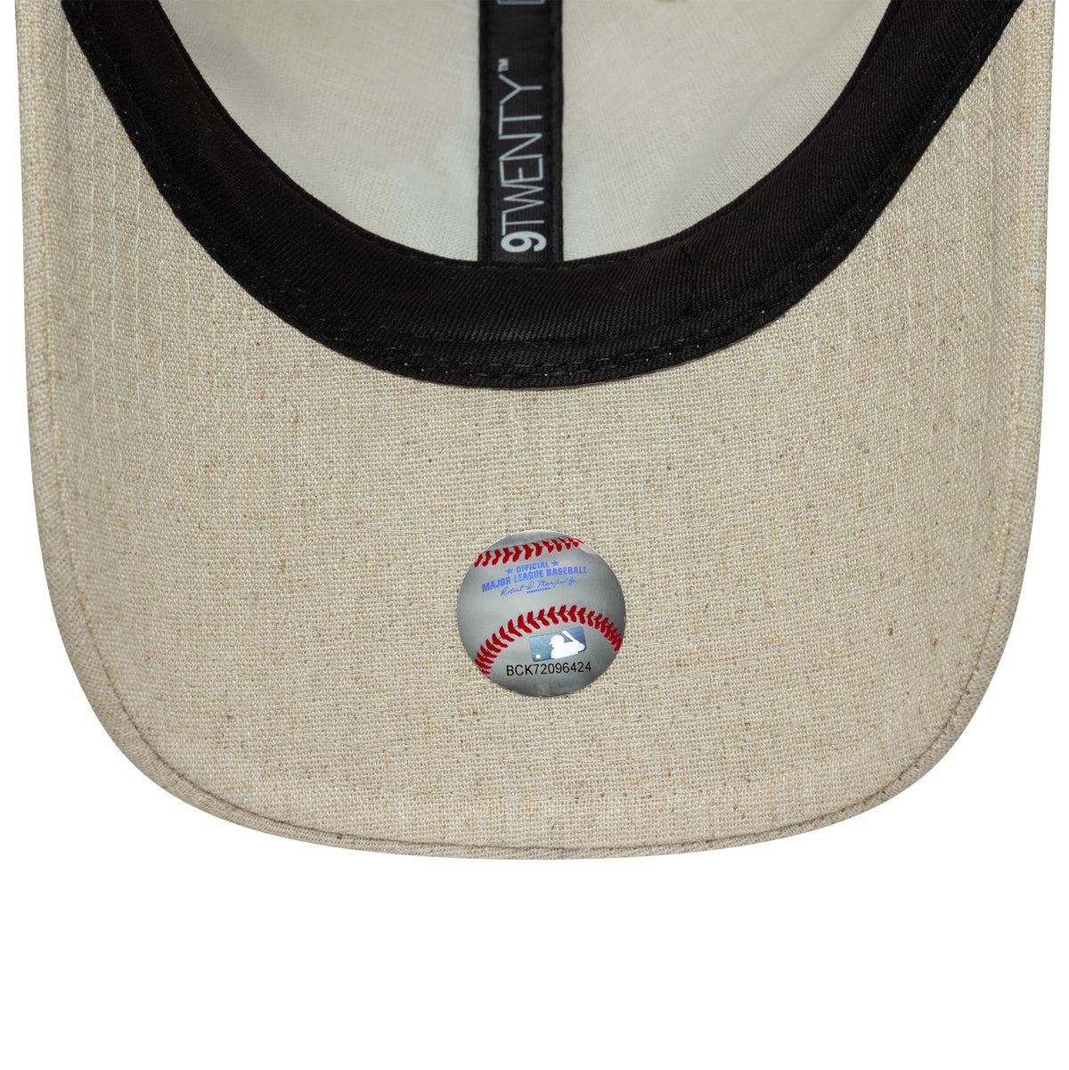 New York Yankees MLB Linen Light Beige New Era 9TWENTY Adjustable Cap, inside view showing black taping with the 9TWENTY logo, a white sweatband, and a baseball-themed sticker on the light beige undervisor.