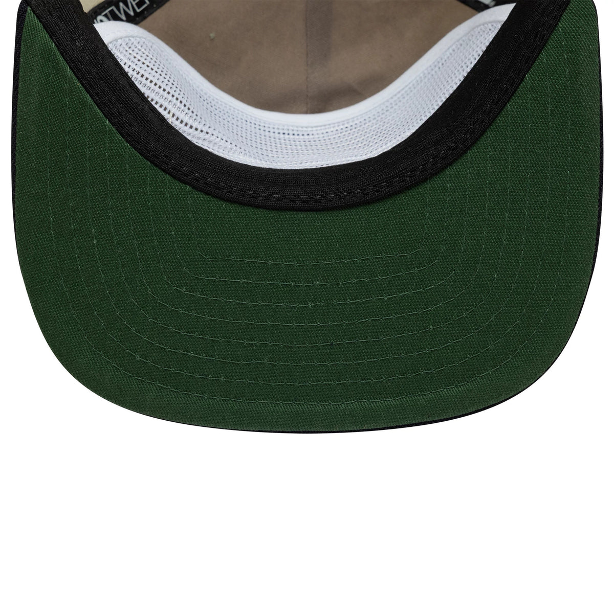 New Era Outdoor Graphic Light Beige 19TWENTY Adjustable Cap, inside view showing the dark green undervisor with curved stitching, brown sweatband, white interior mesh, and New Era branded taping.