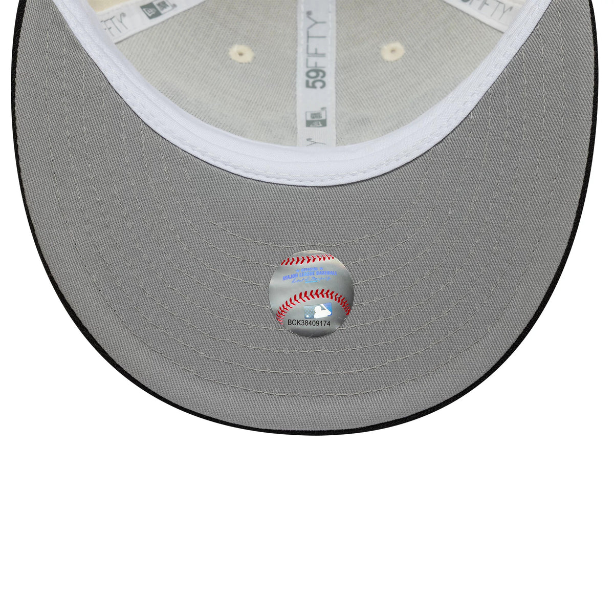 New York Yankees MLB Cooperstown Cream Low Profile New Era 59FIFTY Fitted Cap, inside view showing a grey undervisor with a baseball sticker, white sweatband and grey 59FIFTY taping on the panel seams.