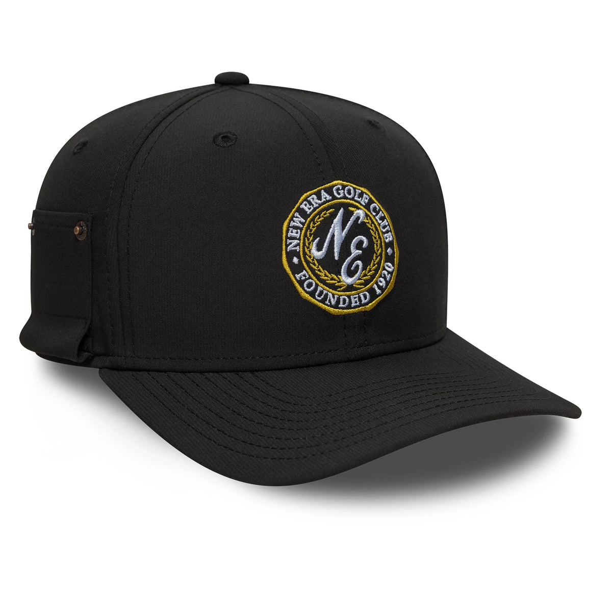 New Era Technical Black 9SEVENTY Stretch Snap Adjustable Cap, three-quarter view showing the intricately embroidered circular golf club logo on the front panel, with a black curved visor and embroidered eyelets.