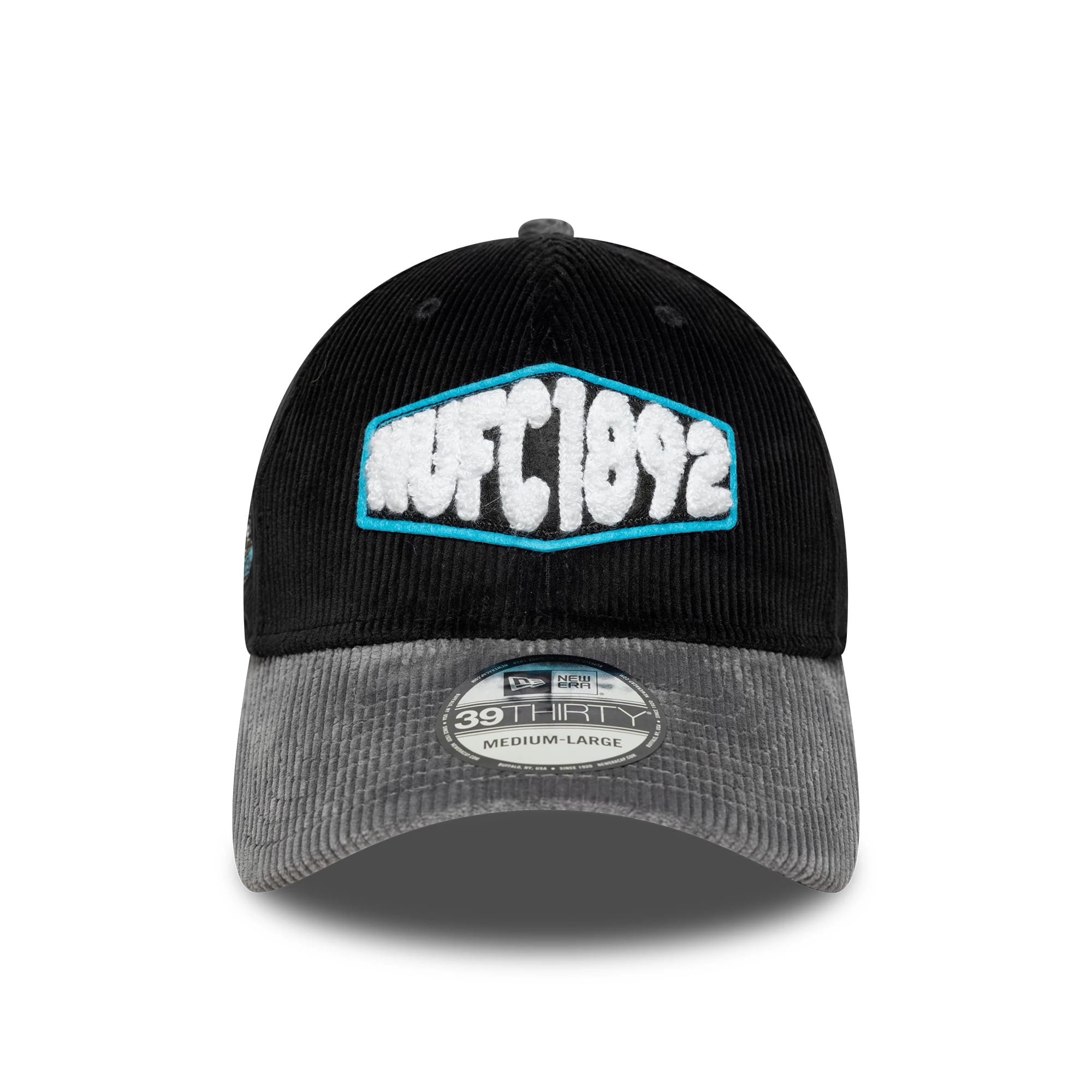 Newcastle United FC Cord Black New Era 39THIRTY Stretch Fit Cap, front view showing a textured NUFC 1892 logo with white and blue embroidery on the structured black crown, complemented by a grey corduroy visor with a 39THIRTY size sticker.