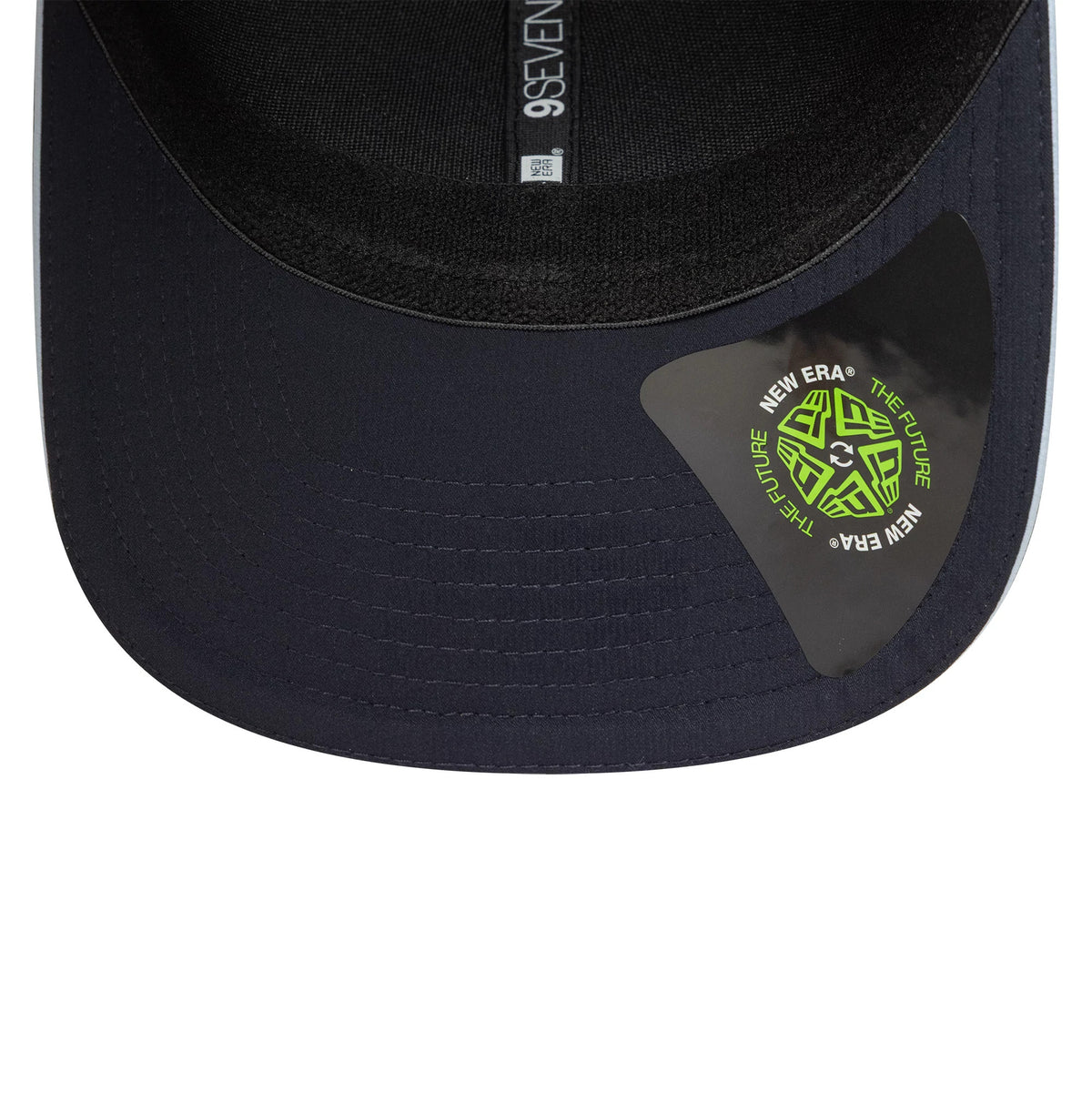 Tottenham Hotspur FC Cockerel Navy New Era 9SEVENTY Stretch Snap Cap, inside view showing black sweatband with grey taping featuring 9SEVENTY branding and a green New Era The Future sticker on the navy undervisor.