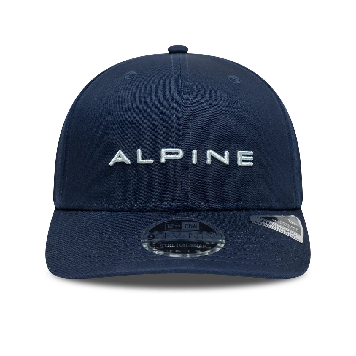 Alpine Racing Navy New Era 9SEVENTY Stretch Snap Cap, front view showing the white embroidered Alpine lettering on the structured navy crown, a curved visor with the 9SEVENTY size sticker, and the New Era flag logo on the left side.