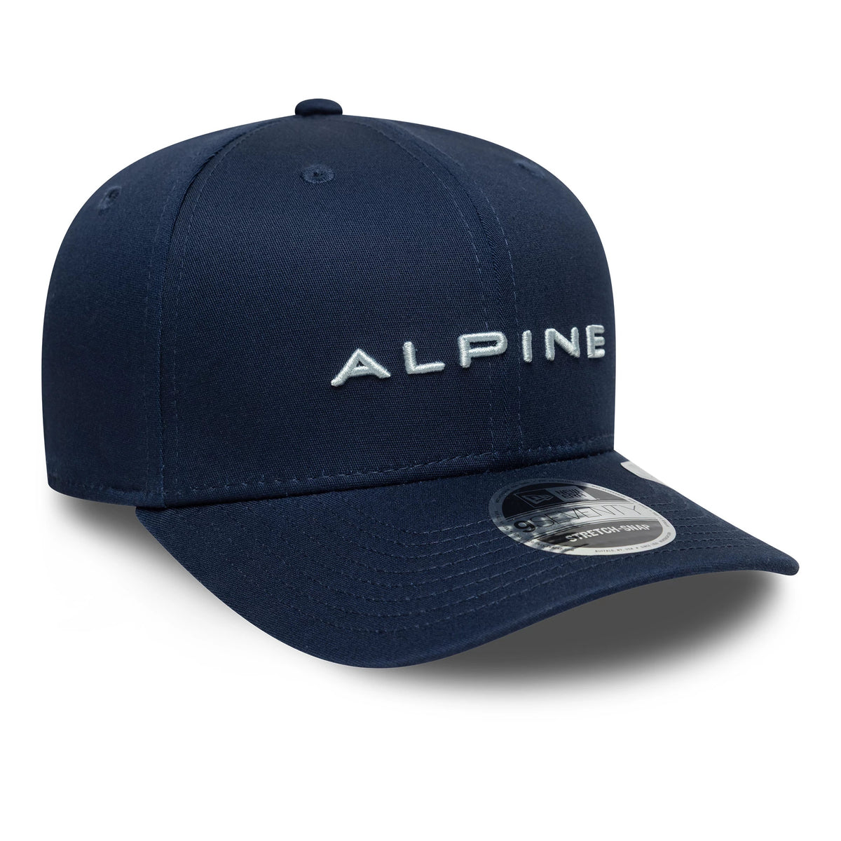 Alpine Racing Navy New Era 9SEVENTY Stretch Snap Cap, front view showing white raised Alpine embroidery on the navy front panel, curved navy visor and a 9SEVENTY size sticker on the top.