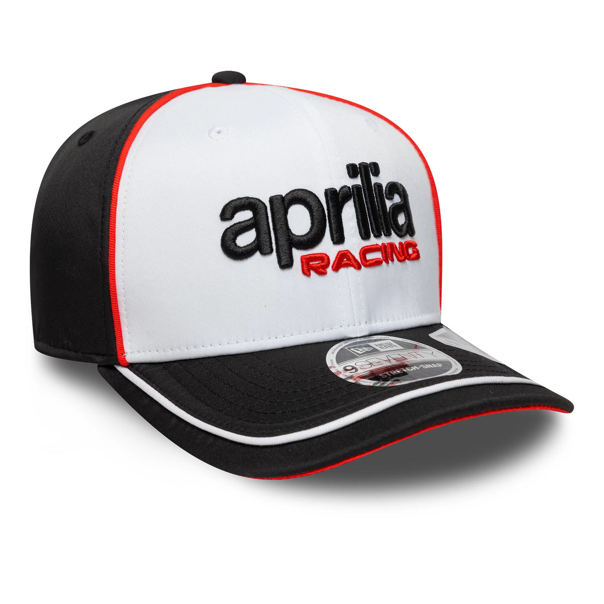 Aprilia Logo White New Era 9SEVENTY Stretch Snap Cap, three-quarter view showing black embroidered aprilia text and red RACING on the white front panel, black visor with red edging, and 9SEVENTY size sticker on the visor.