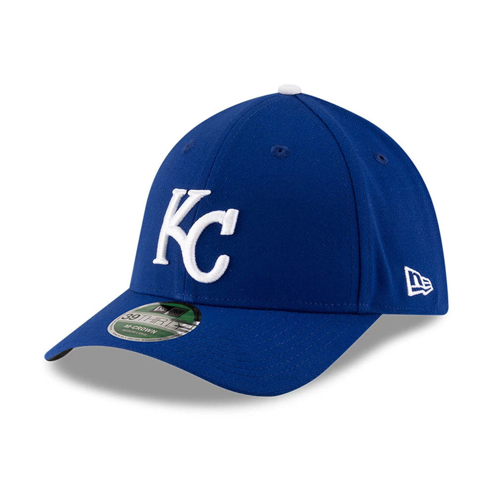 Royals MLB Player Replica Blue New Era 39THIRTY M-Crown Stretch-Fit Cap, three-quarter view showing the white raised embroidered KC logo on the front panel, blue curved visor with a 39THIRTY size sticker, and New Era flag logo on the left side.