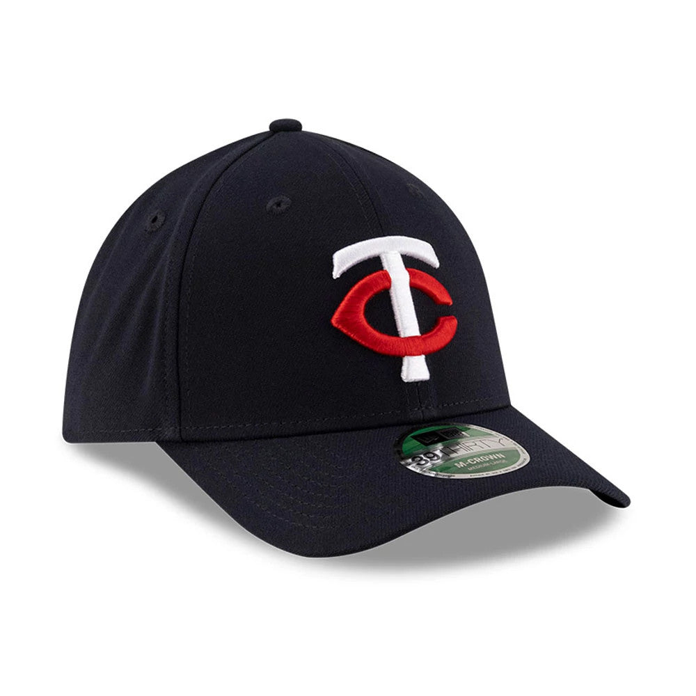 Twins MLB Player Replica Navy New Era 39THIRTY M-Crown Stretch Fit Cap, three-quarter view showing the white and red embroidered TC logo on the front panel, with a navy curved visor and a 39THIRTY size sticker.