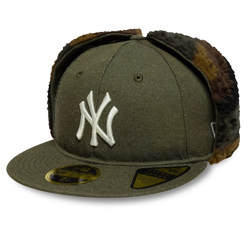 New York Yankees MLB Camo Open Green Retro Crown Dogear New Era 59FIFTY Fitted Cap, three-quarter view showing the white embroidered NY logo on the front panel, with fur-lined dogears and a gold 59FIFTY size sticker on the green visor.