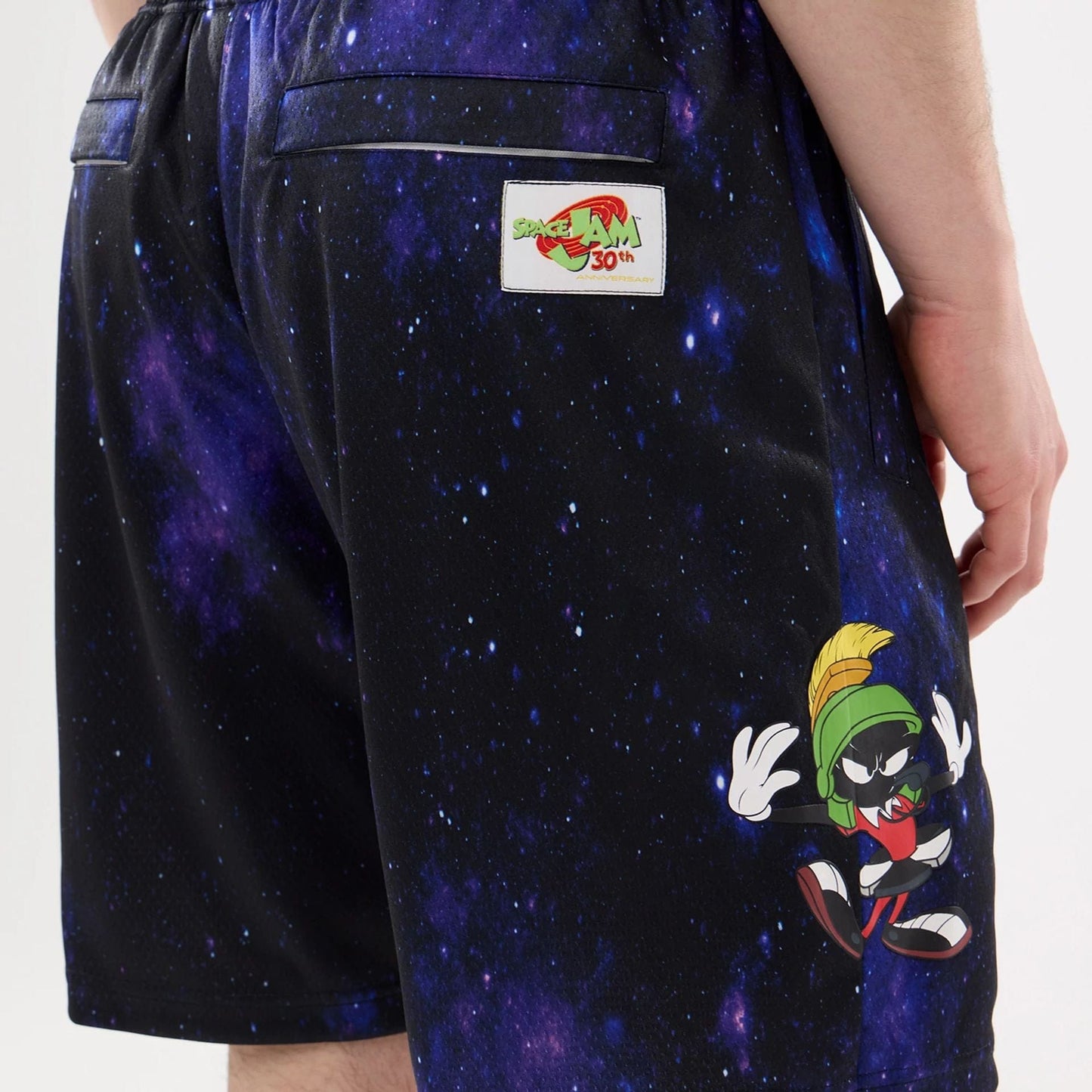 The model is wearing this Warner Brothers Space Jam Oversized Shorts in white. 7