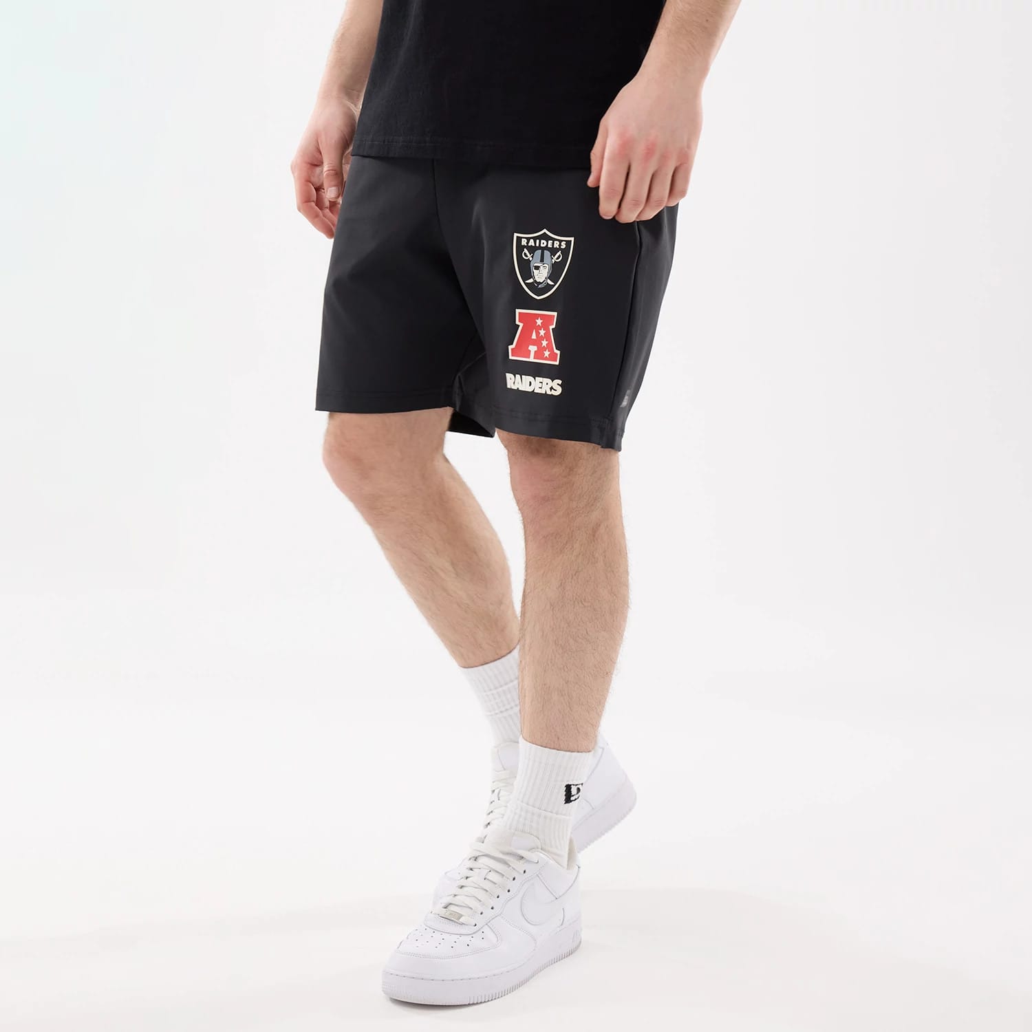 The model is wearing this NFL Match Las Vegas Raiders Oversized Shorts in black. 1