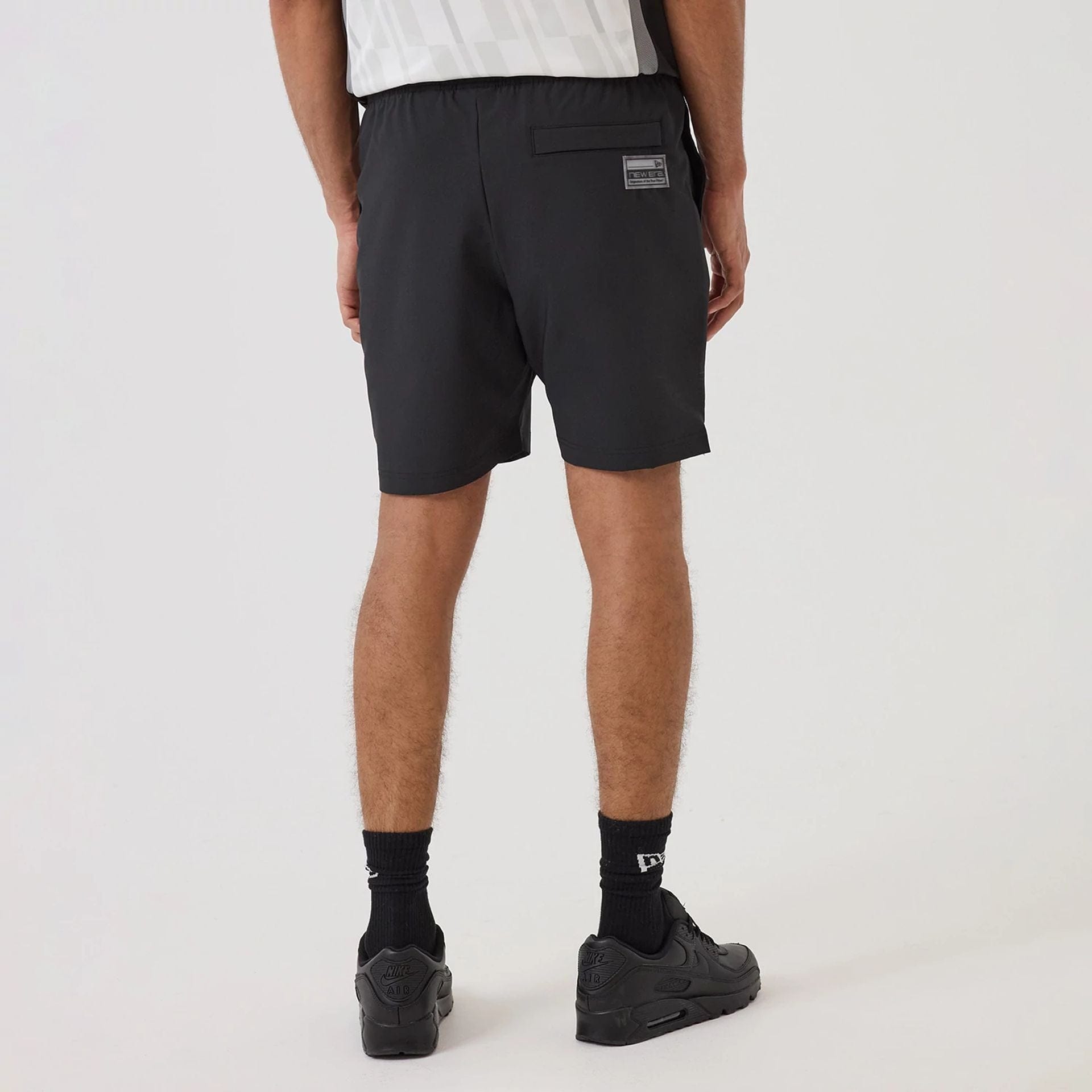 The model is wearing this NBA Match Brooklyn Nets Oversized Shorts in black. 2