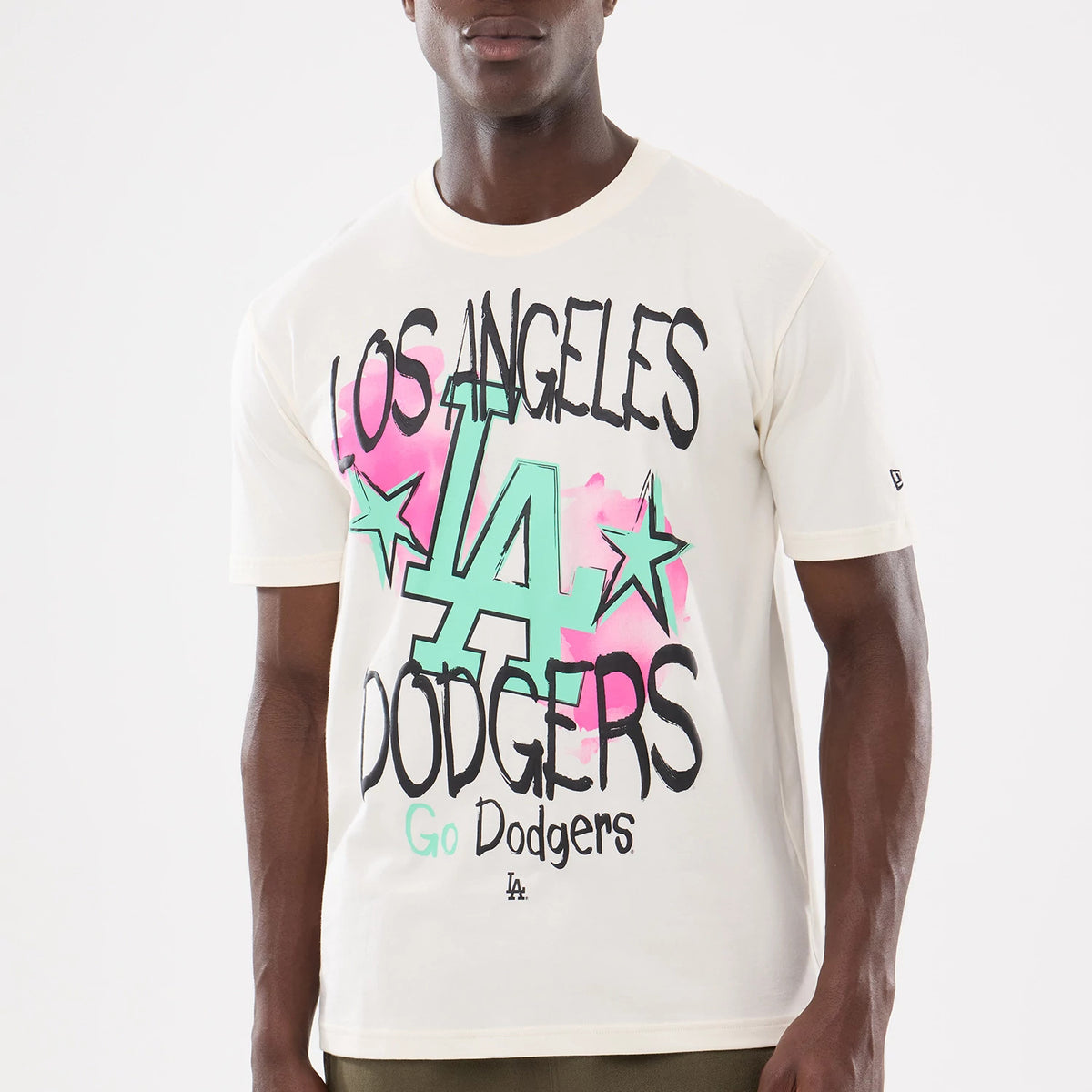 New Era LA Dodgers MLB Street Art Graphic Light Beige T-Shirt, front view on-model a LA print with pink and mint green accents, Los Angeles Dodgers lettering, and a small New Era embroidered logo on the sleeve.