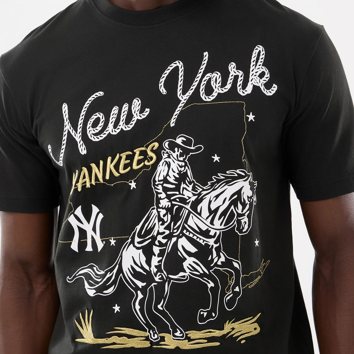 The model is wearing this MLB Cowboy Graphic New York Yankees T-Shirt in black. 4