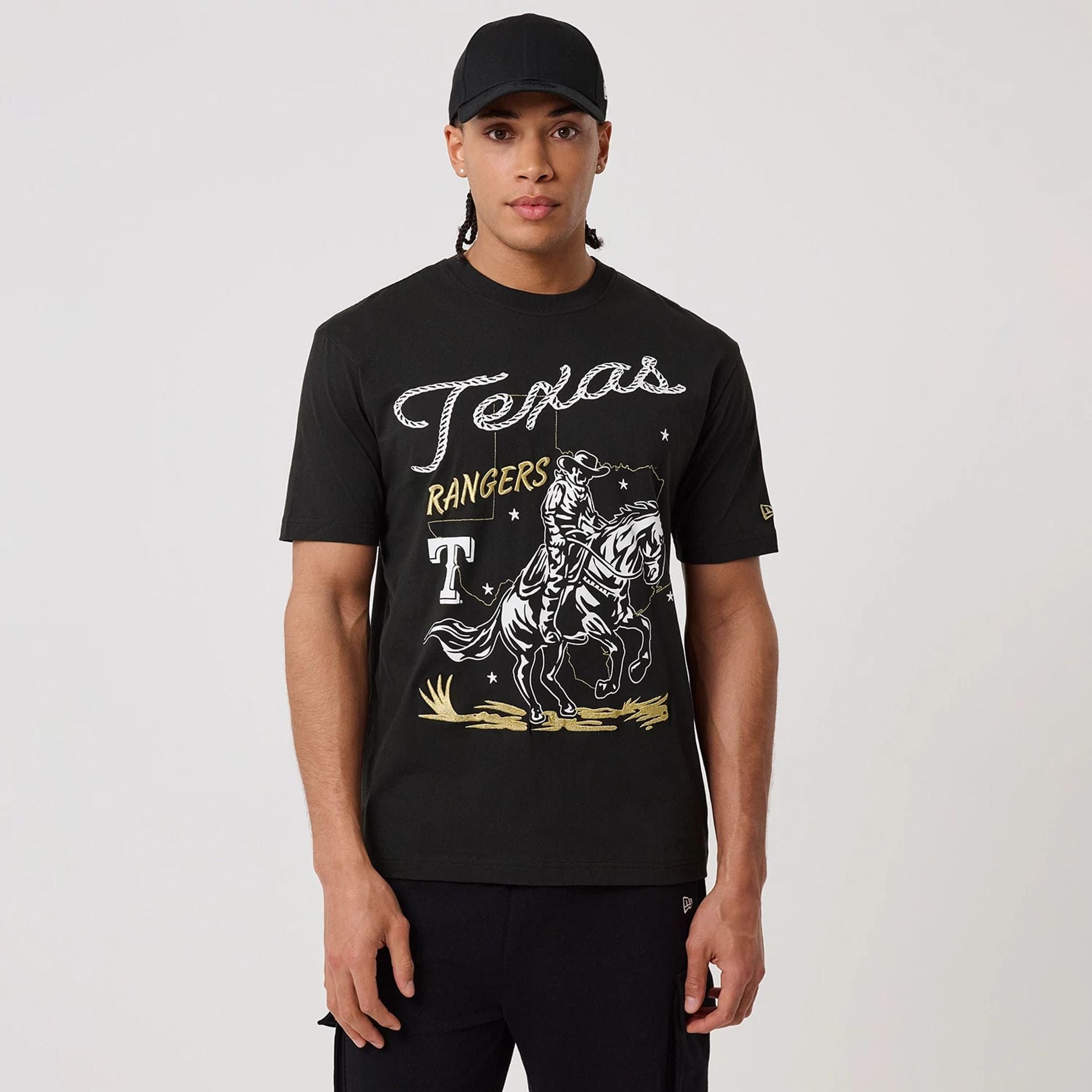 The model is wearing this MLB Cowboy Graphic Texas Rangers T-Shirt in black. 1