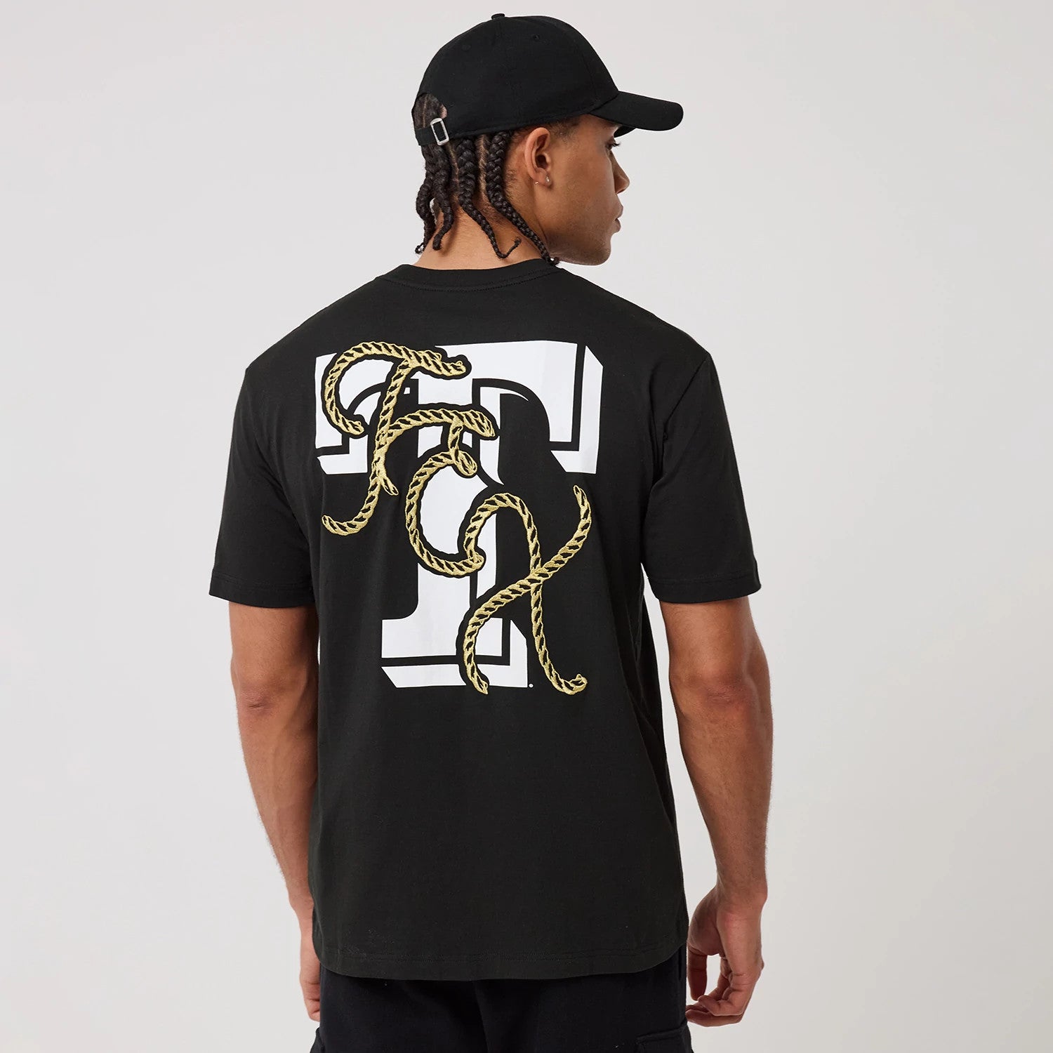 The model is wearing this MLB Cowboy Graphic Texas Rangers T-Shirt in black. 2