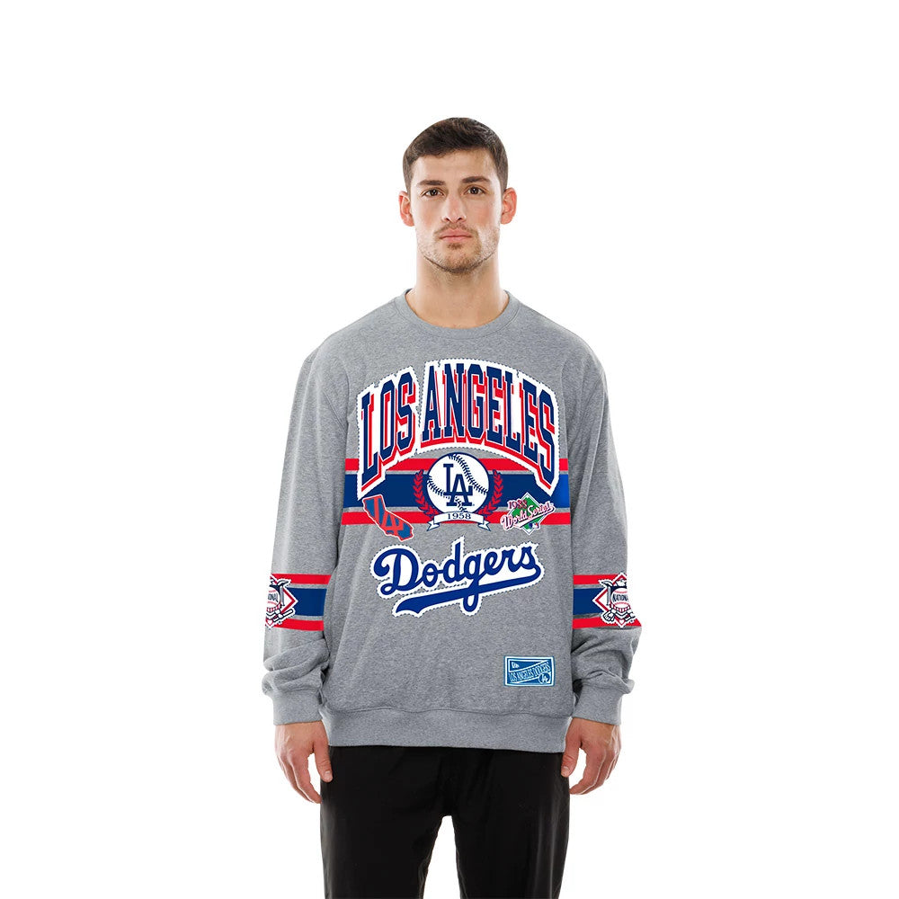 New Era LA Dodgers MLB Sport Classic Grey Crew Neck Sweater, front view on a model showing the Los Angeles Dodgers logo with red and blue accents, the 1988 World Series patch on the sleeve, and a vintage MLB patch near the hem.