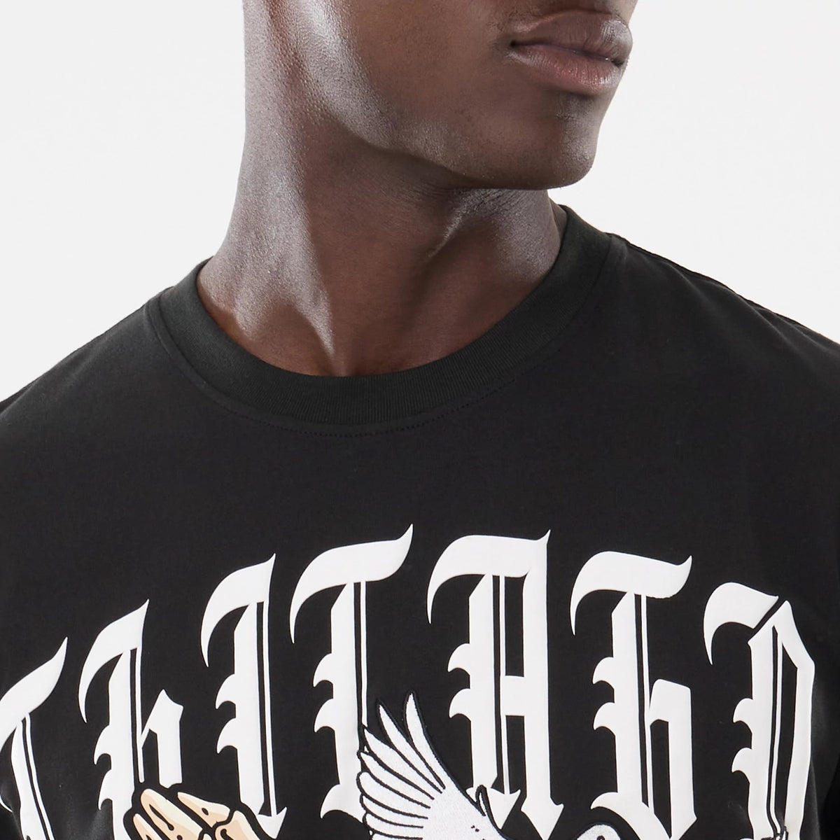 New Era Chicago White Sox MLB Script Graphic Black T-Shirt, front view on-model showcasing white gothic lettering across the chest with a detailed graphic of praying hands and wings, set against a solid black background.