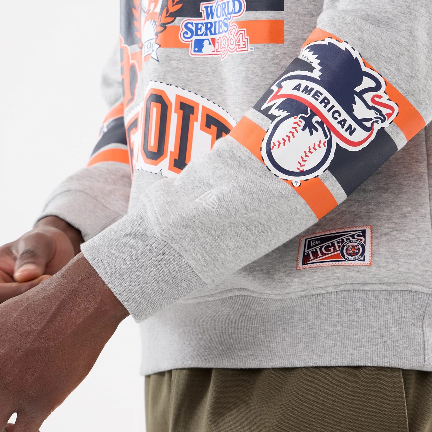 The model is wearing this MLB Sport Classic Detroit Tigers Crew Neck Sweater in grey. 3