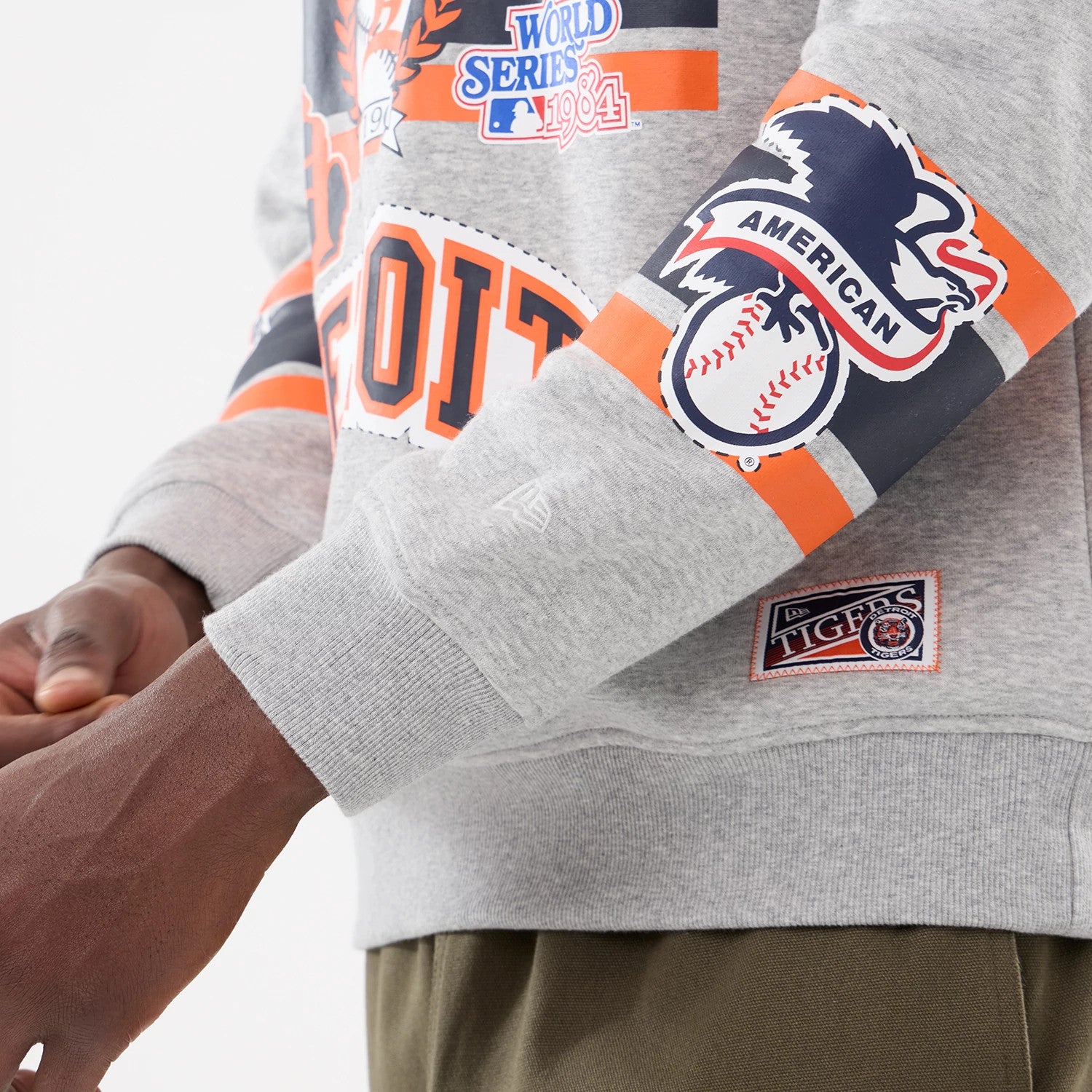 The model is wearing this MLB Sport Classic Detroit Tigers Crew Neck Sweater in grey. 3