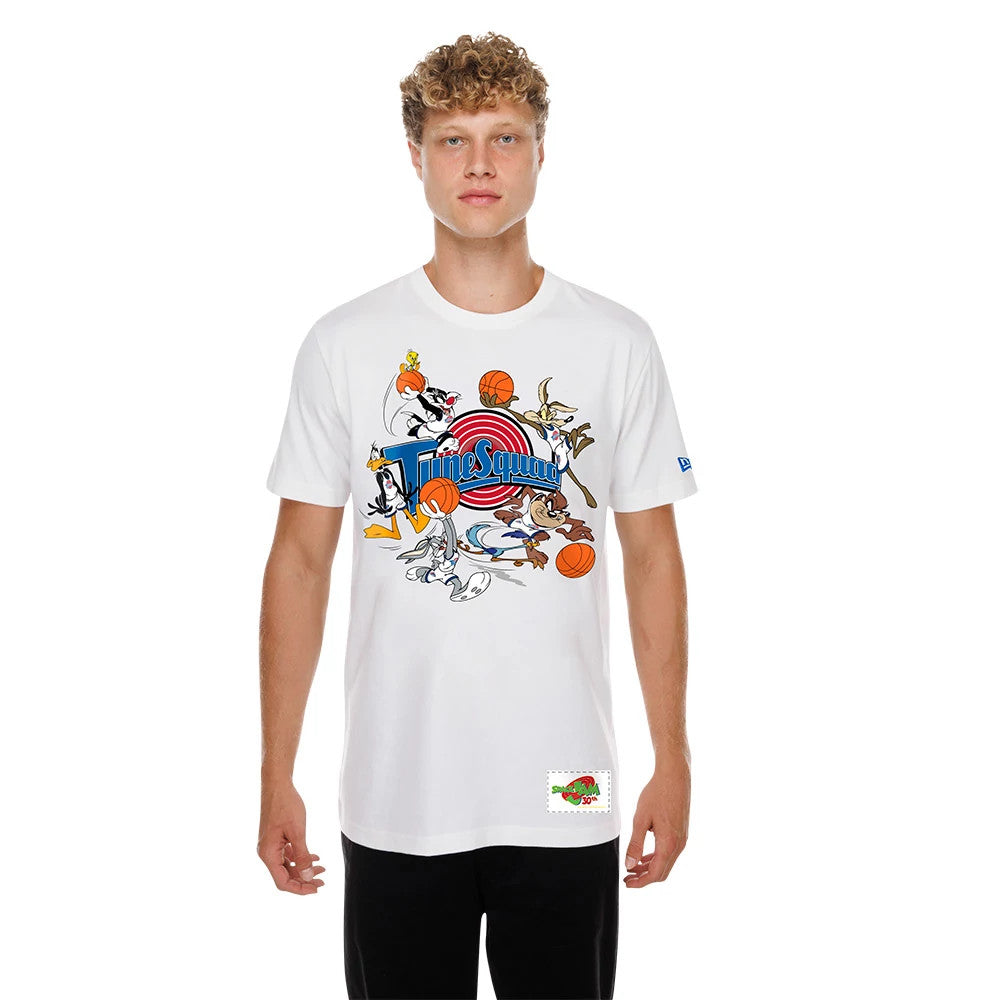 New Era Space Jam Tune Squad White T-Shirt, front view on-model showing a colourful graphic of Looney Tunes characters playing basketball centred across the chest with a small embroidered New Era logo on the left sleeve.