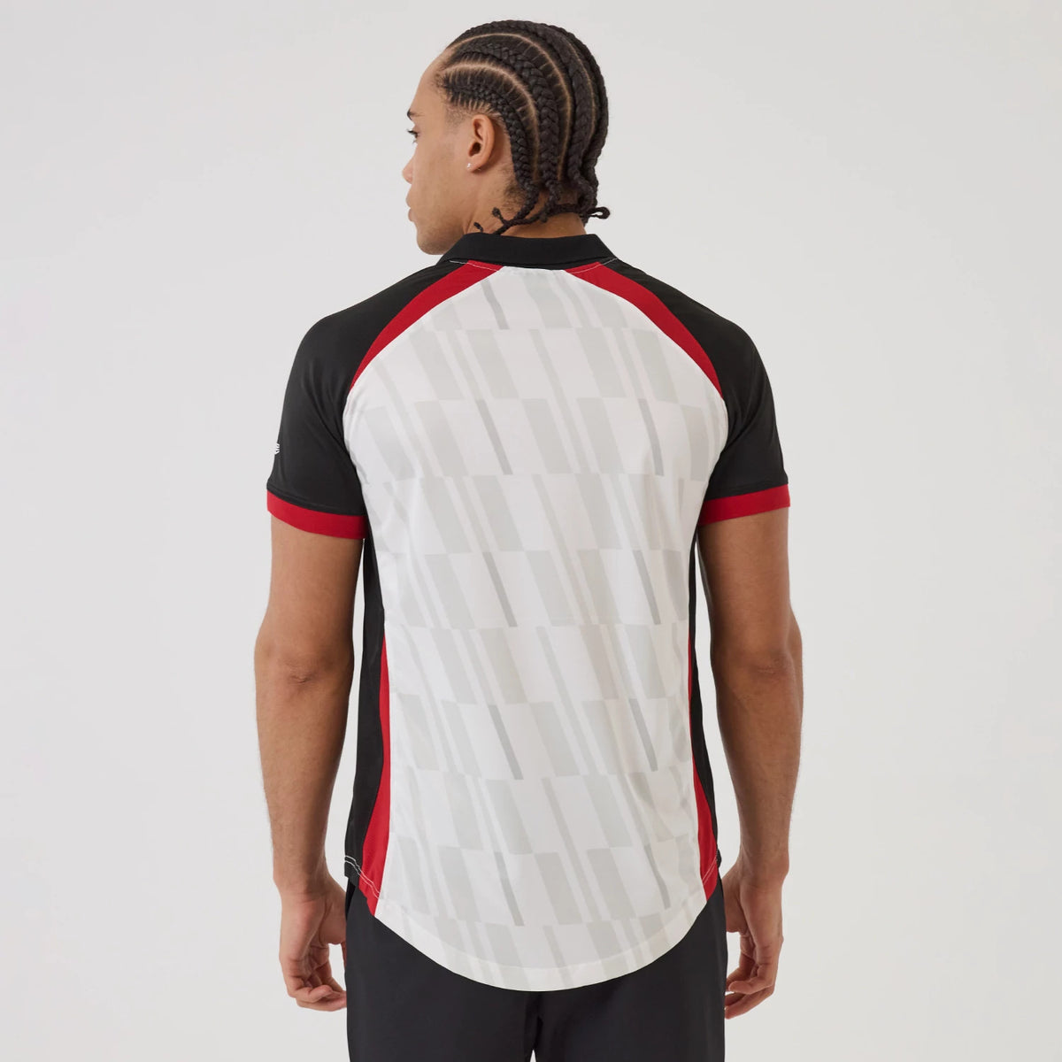 New Era Chicago Bulls NBA Match White T-Shirt, back view on a model showing a geometric pattern across the white back panel, black sleeves with red accents, and a raised New Era logo on the left sleeve.