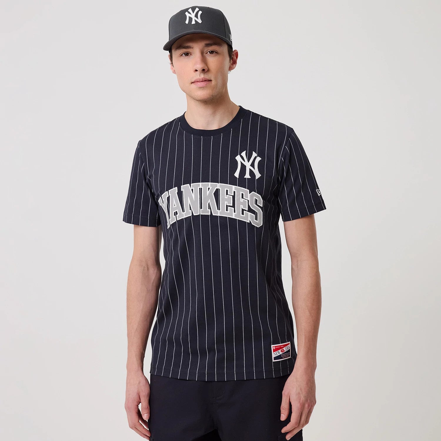 The model is wearing this MLB Pinstripe New York Yankees T-Shirt in navy. 1