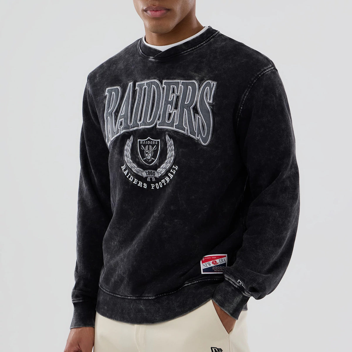 The model is wearing this NFL Las Vegas Raiders Laurel Wreath Crew Neck Sweater in black. 4