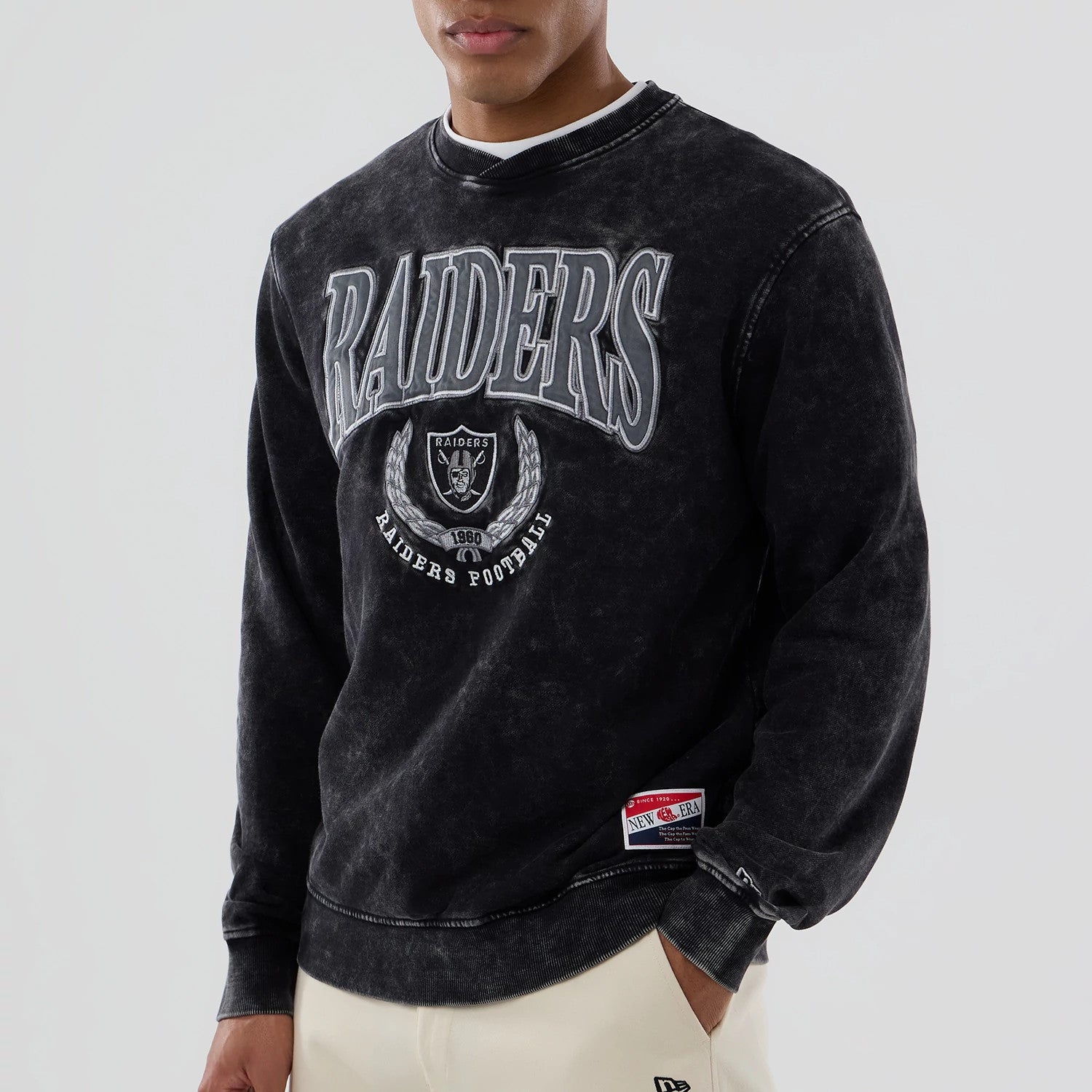 The model is wearing this NFL Las Vegas Raiders Laurel Wreath Crew Neck Sweater in black. 4