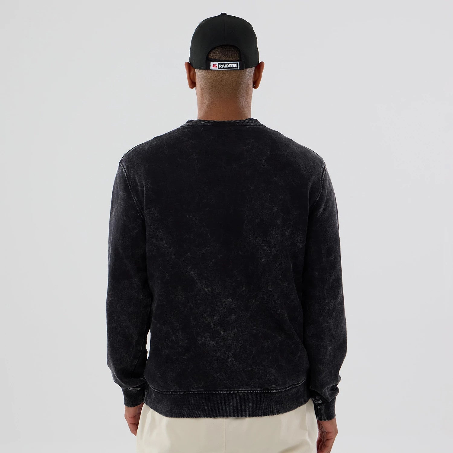 The model is wearing this NFL Las Vegas Raiders Laurel Wreath Crew Neck Sweater in black. 2