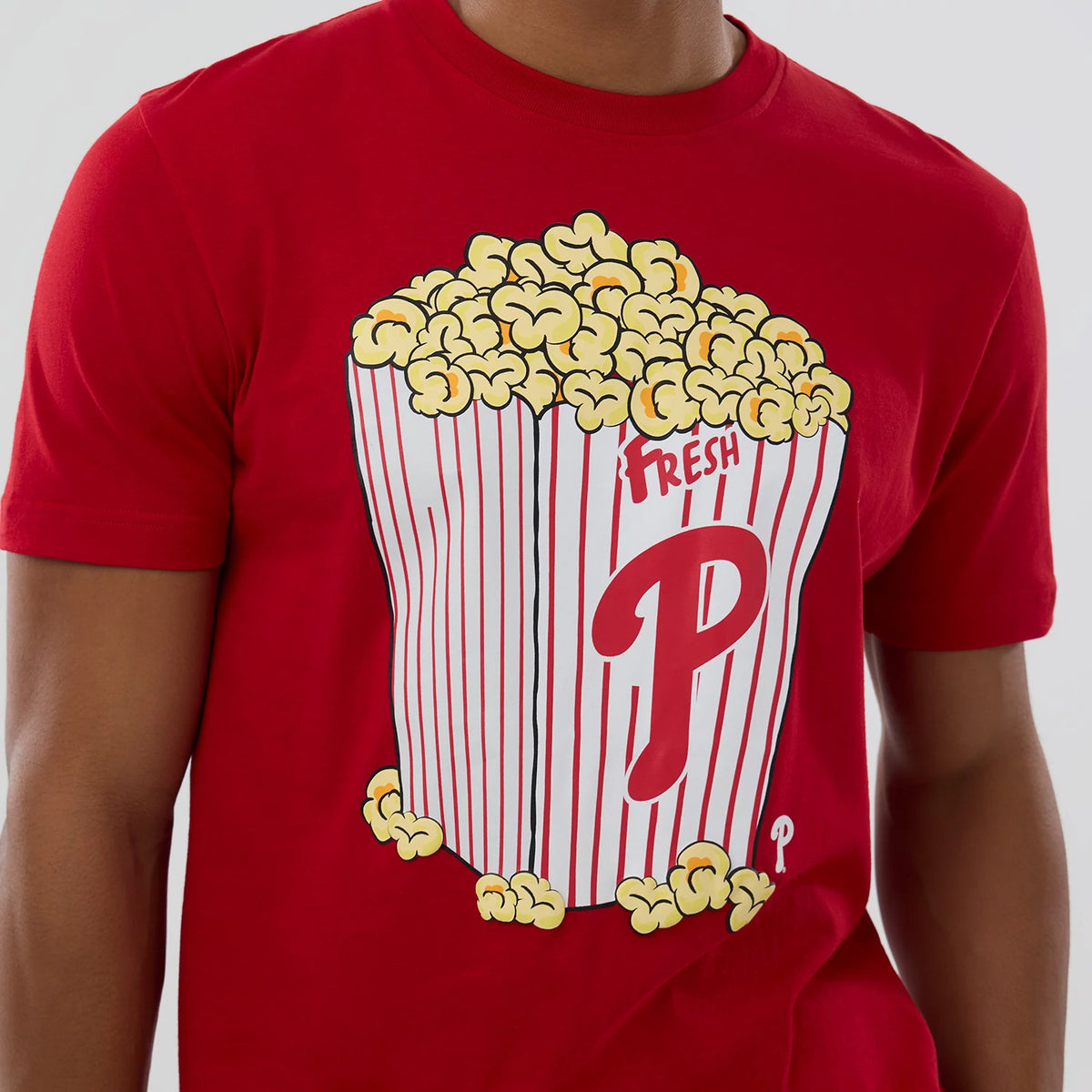 New Era Philadelphia Phillies MLB Popcorn Red T-Shirt, front view featuring a graphic of a striped popcorn box overflowing with popcorn, with a large red P printed on the front and the word Fresh above.