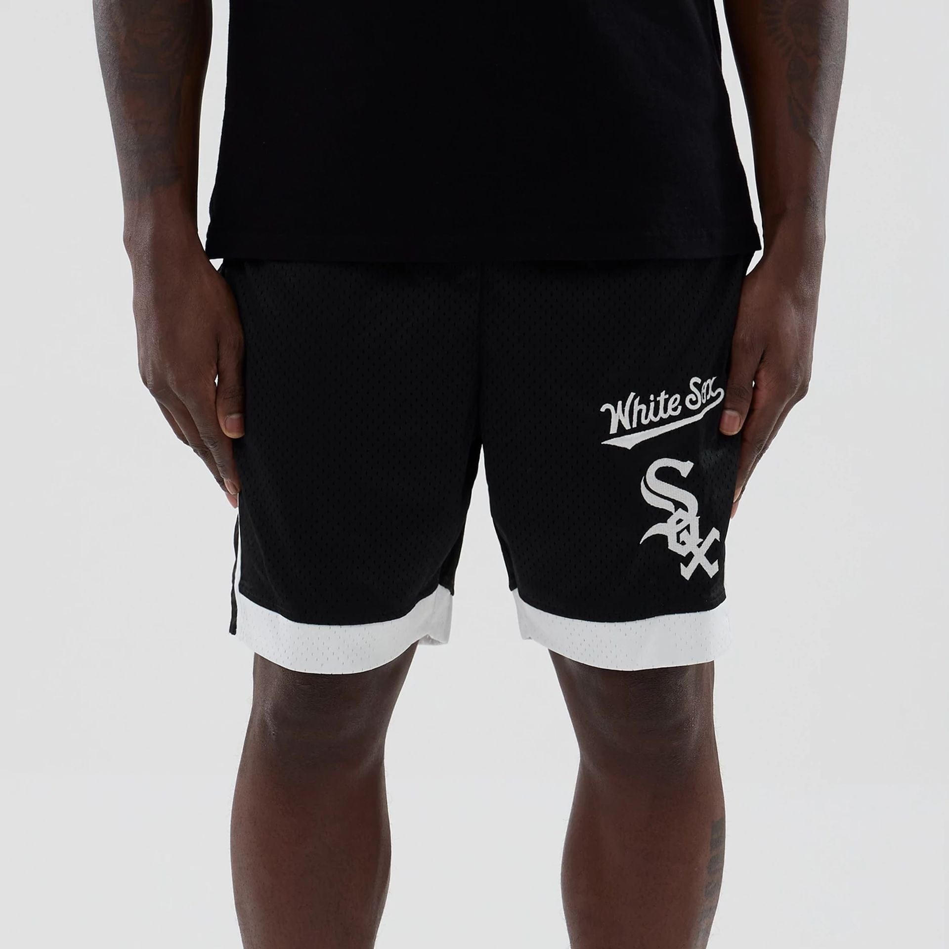 The model is wearing these MLB Chicago White Sox Mesh Shorts in black. 2