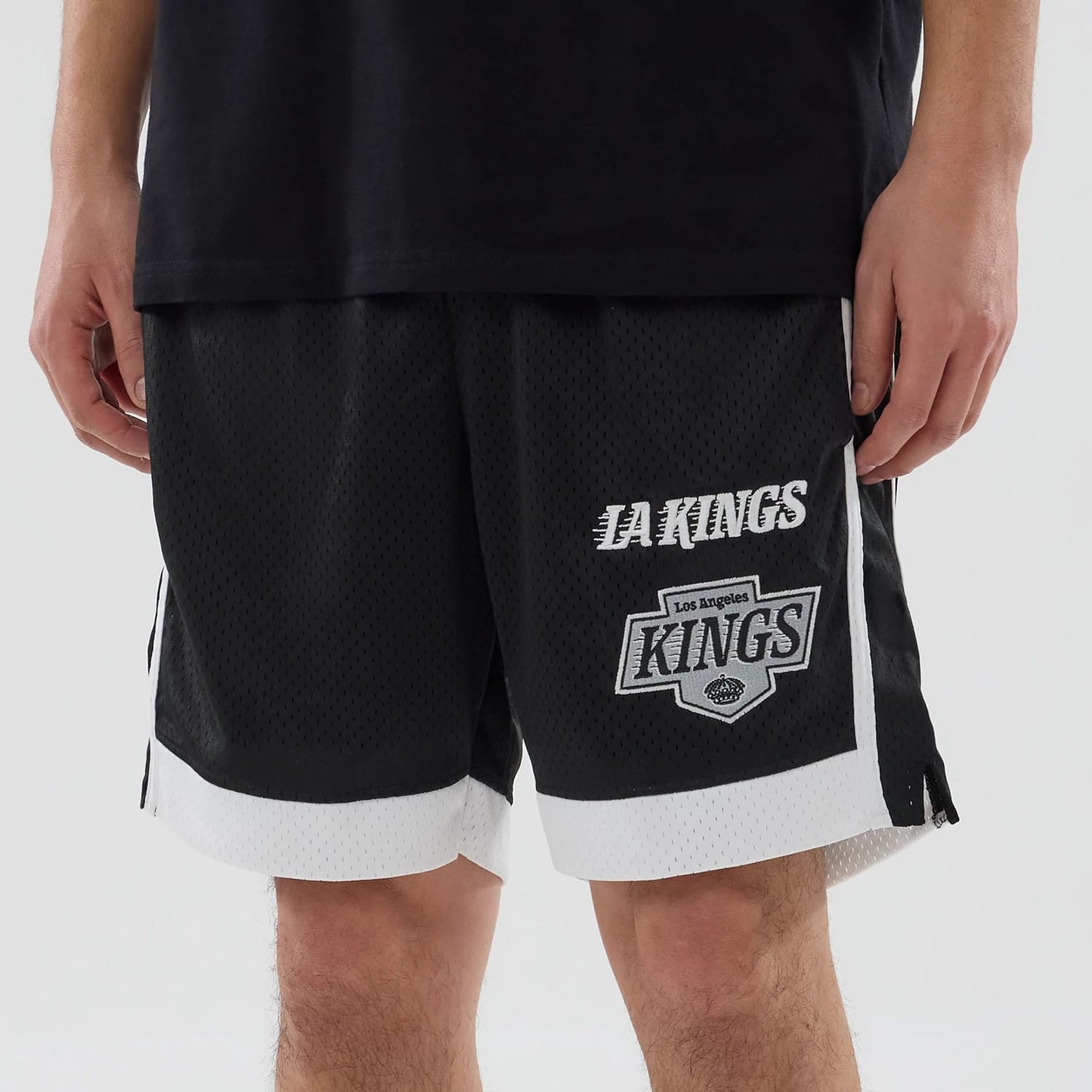 The model is wearing these NHL LA Kings Mesh Shorts in black. 5