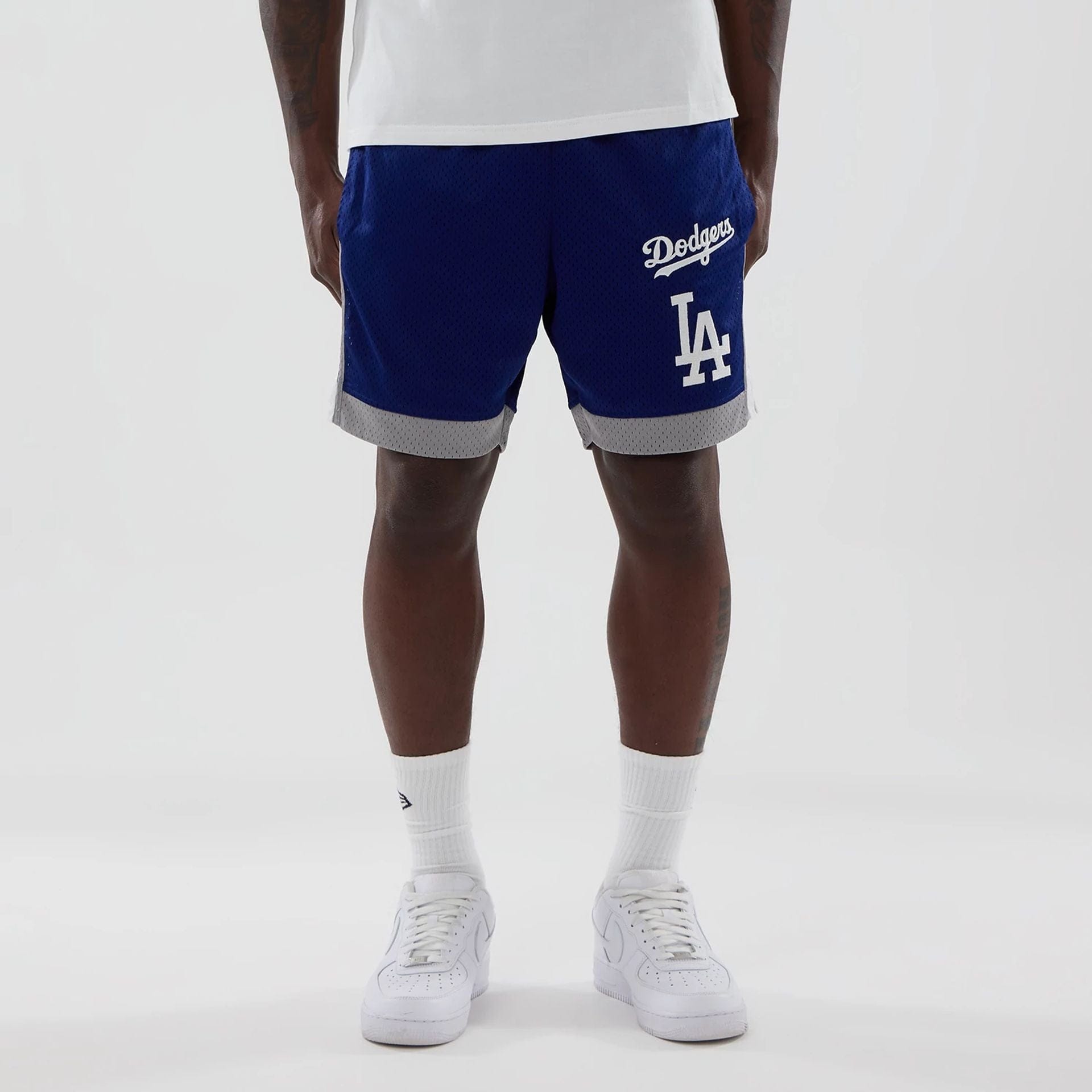 The model is wearing these MLB LA Dodgers Mesh Shorts in dark blue. 1