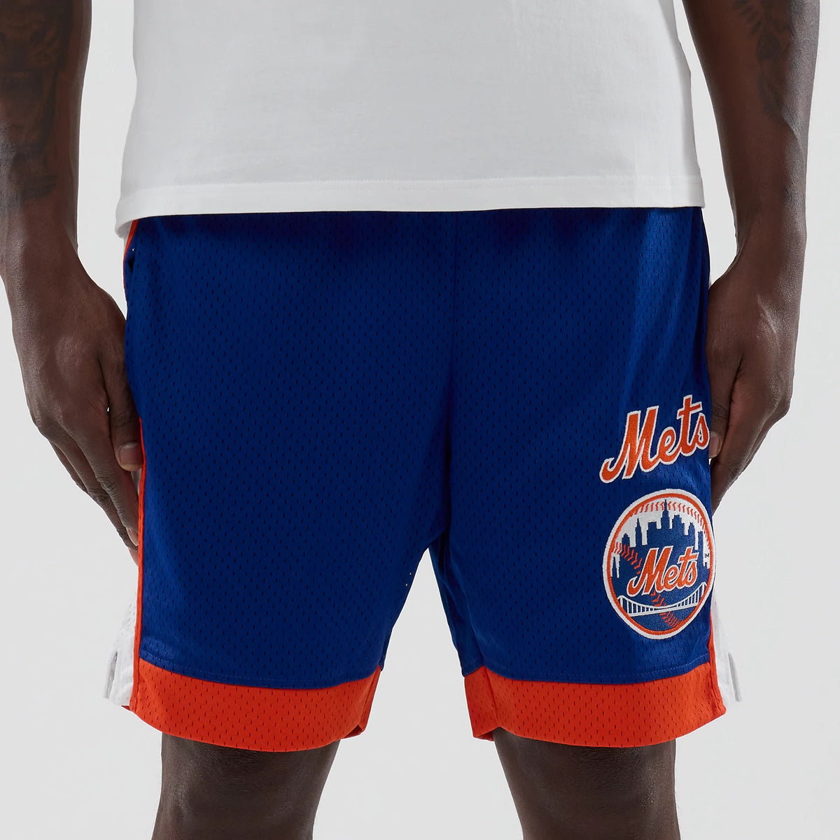 New Era New York Mets MLB Blue Mesh Shorts, front view showing the blue mesh fabric with bright orange trim, featuring an embroidered Mets logo on the left leg and matching script logo above.
